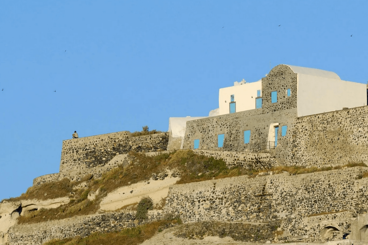 Venetian Castle ruins (Kasteli) at the top of Pyrgos Santorini, with stunning panoramic caldera and Aegean Sea views.