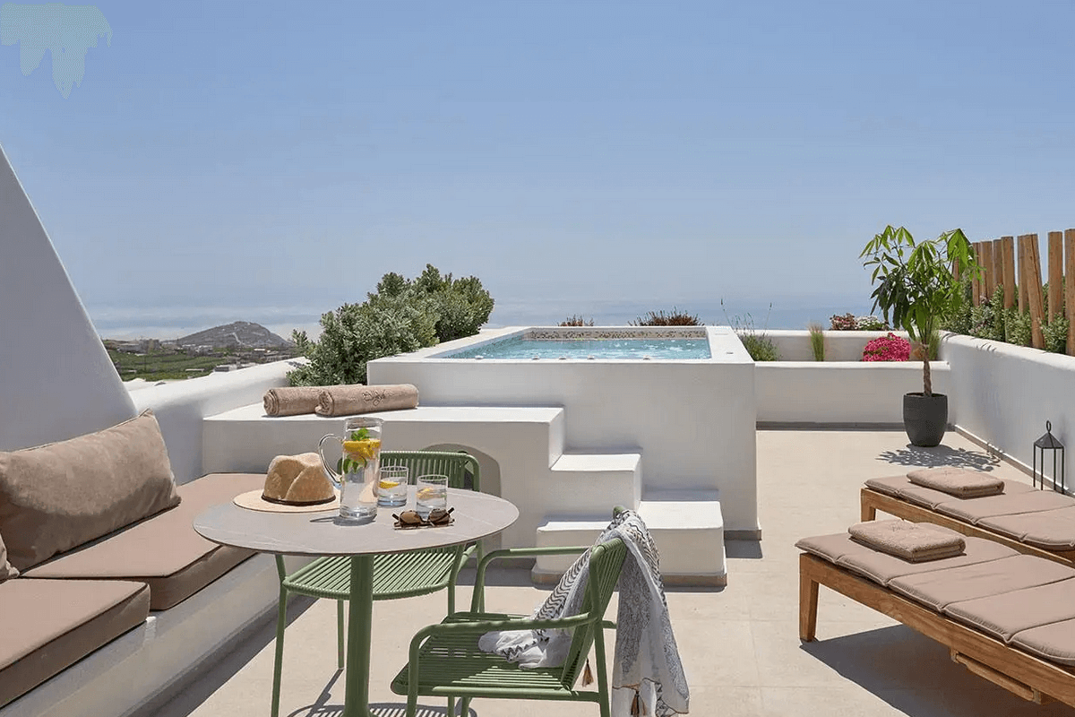 Modern cave-inspired suite with pool views at Alleys Hotel Santorini in Pyrgos, offering luxury and relaxation.