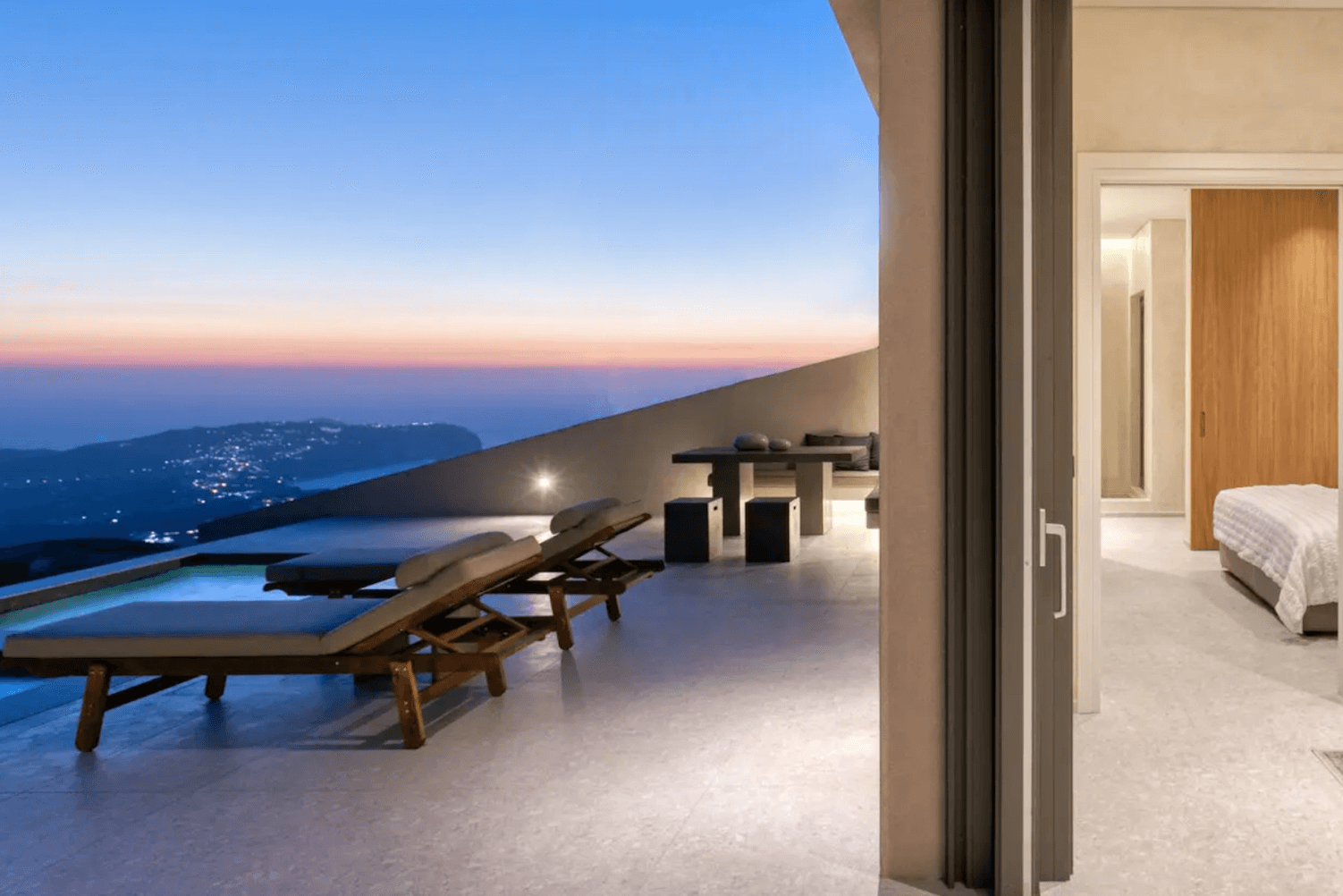 Private pool with panoramic views at Santorini Sky Luxury Resort in Pyrgos, Santorini, offering luxury and serenity.