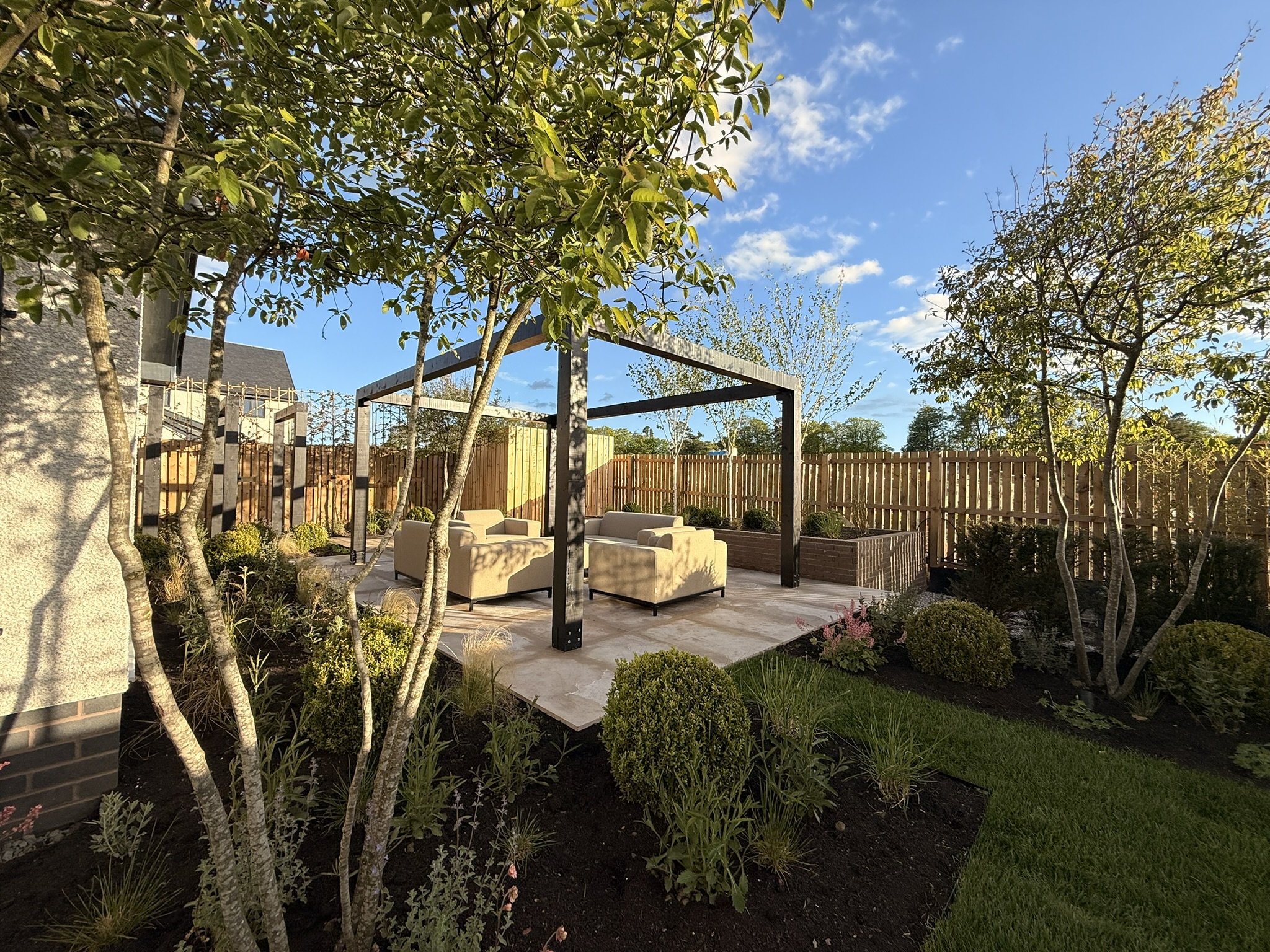 contemporary lounging patio with black pergola