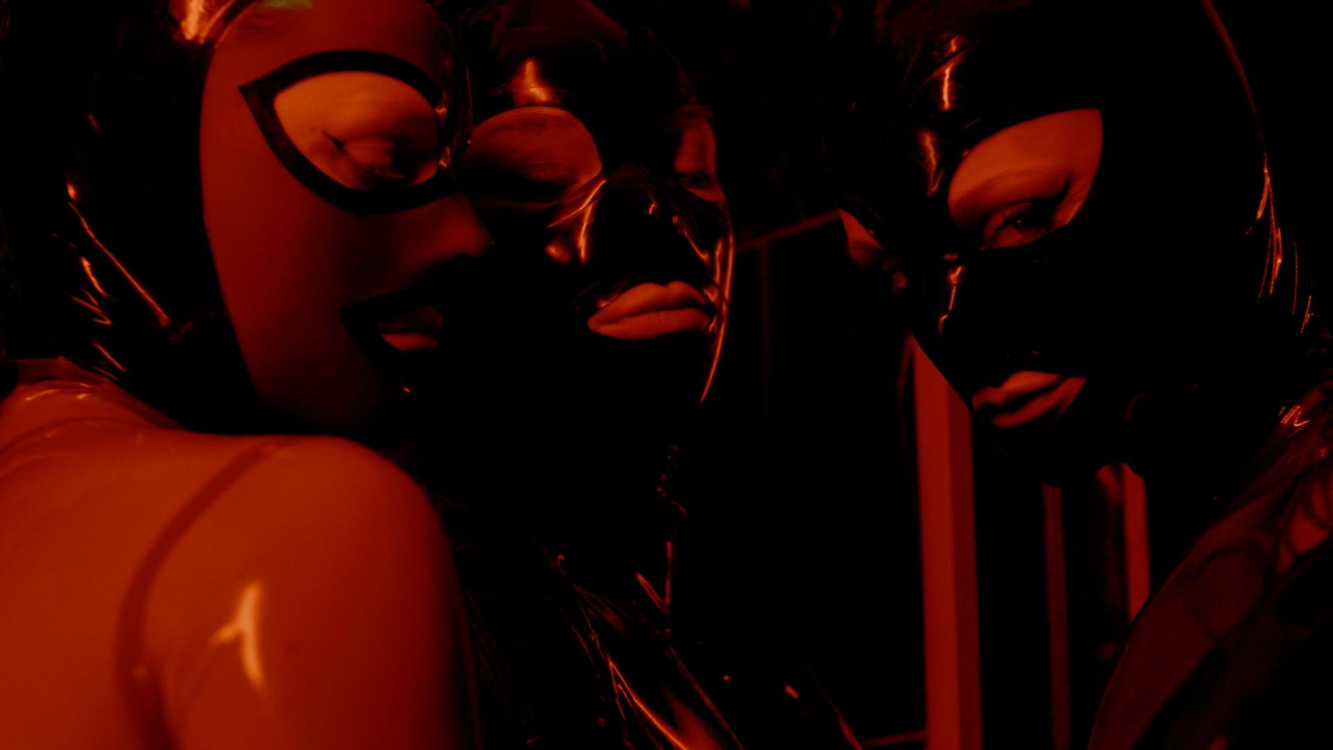 Scenic landscape of a lake surrounded by green hills and mountains under a cloudy sky.