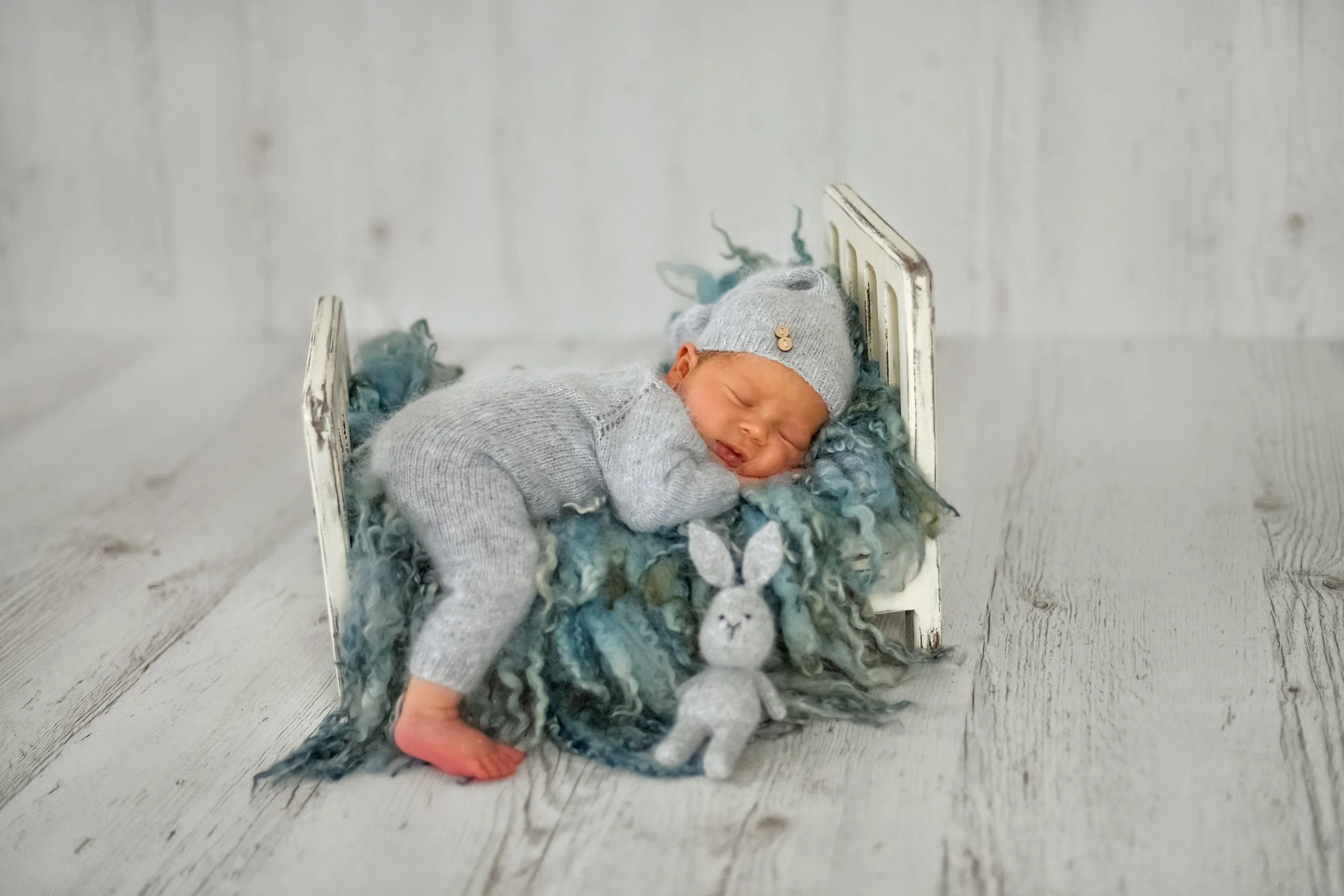 New baby sleeping, doula providing postnatal support to new baby and mum