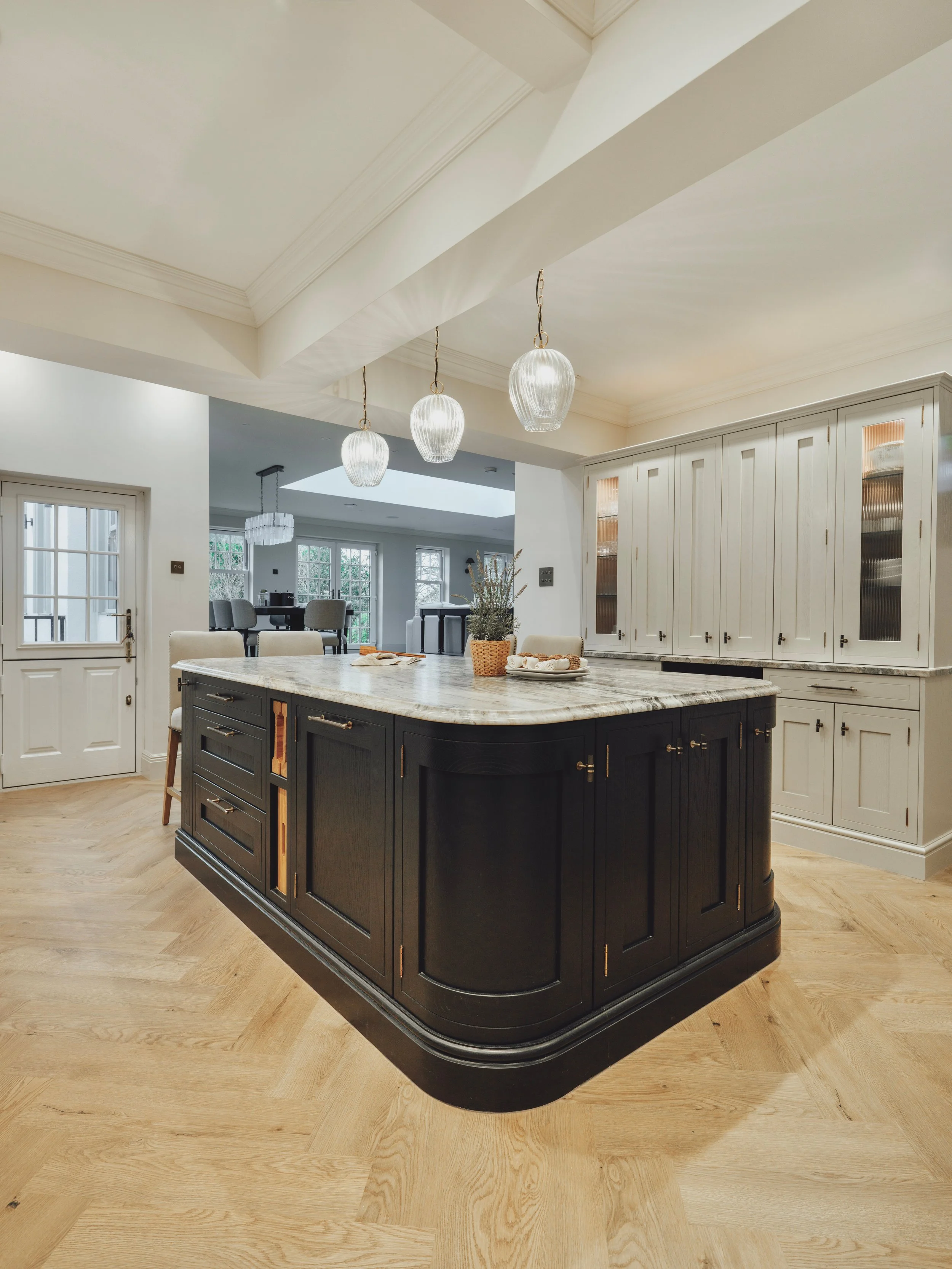 Dresser and Island cabinetry detail shot detailing reeded glass doors and coffered ceiling at Project Orton.
