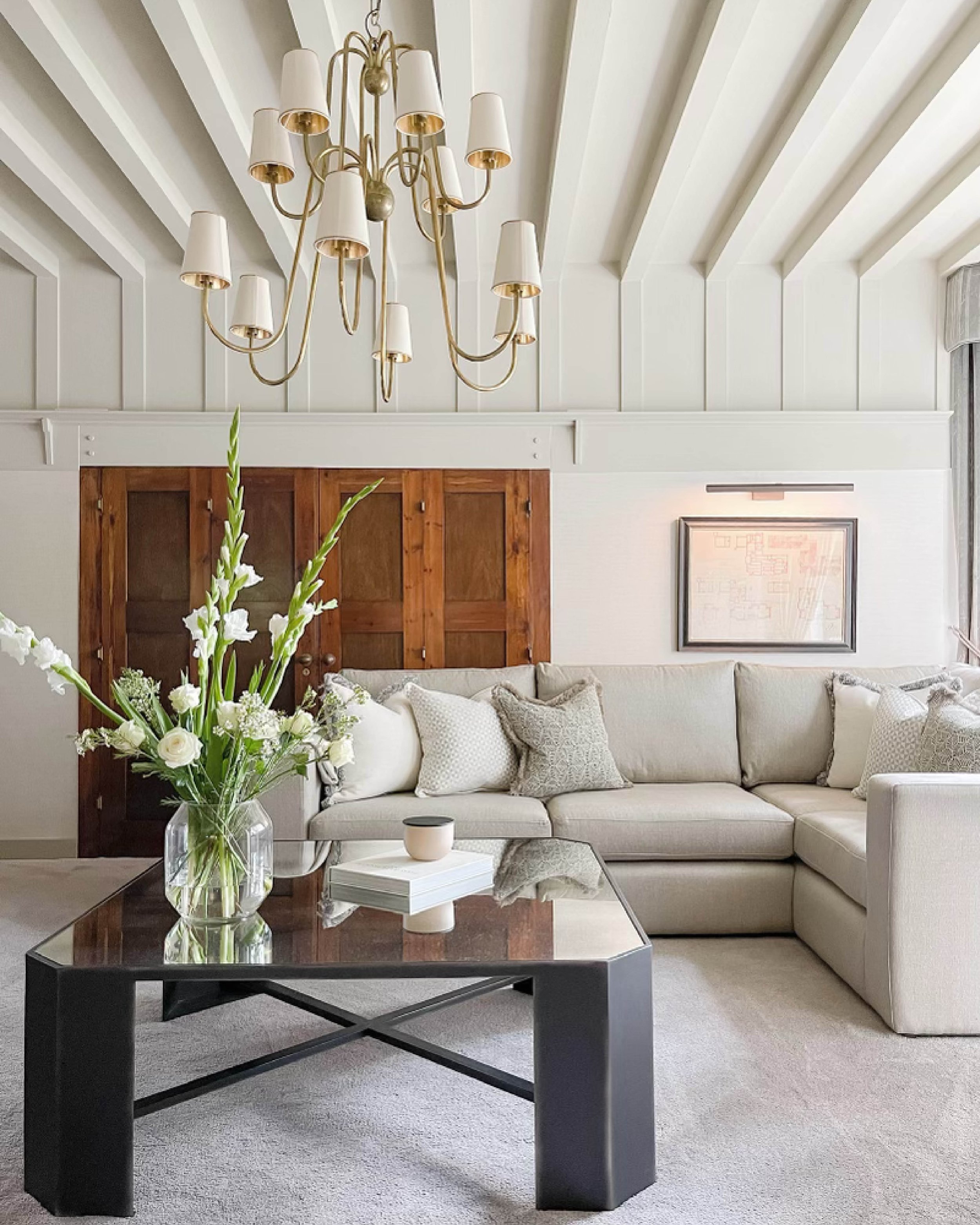 Living room of a Grade II listed family home in the West Midlands designed by Istigh Interiors, featuring original beams, bespoke furnishings and layered neutral tones.