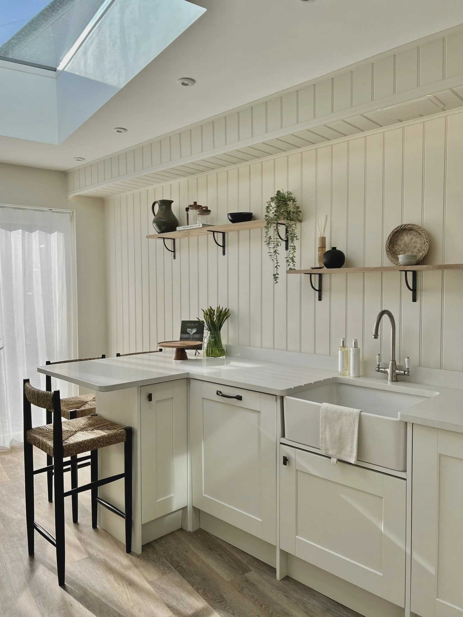 Shaker kitchen in Project Brixham, Devon, featuring open shelving, a Belfast sink, natural oak accents and a large rooflight.