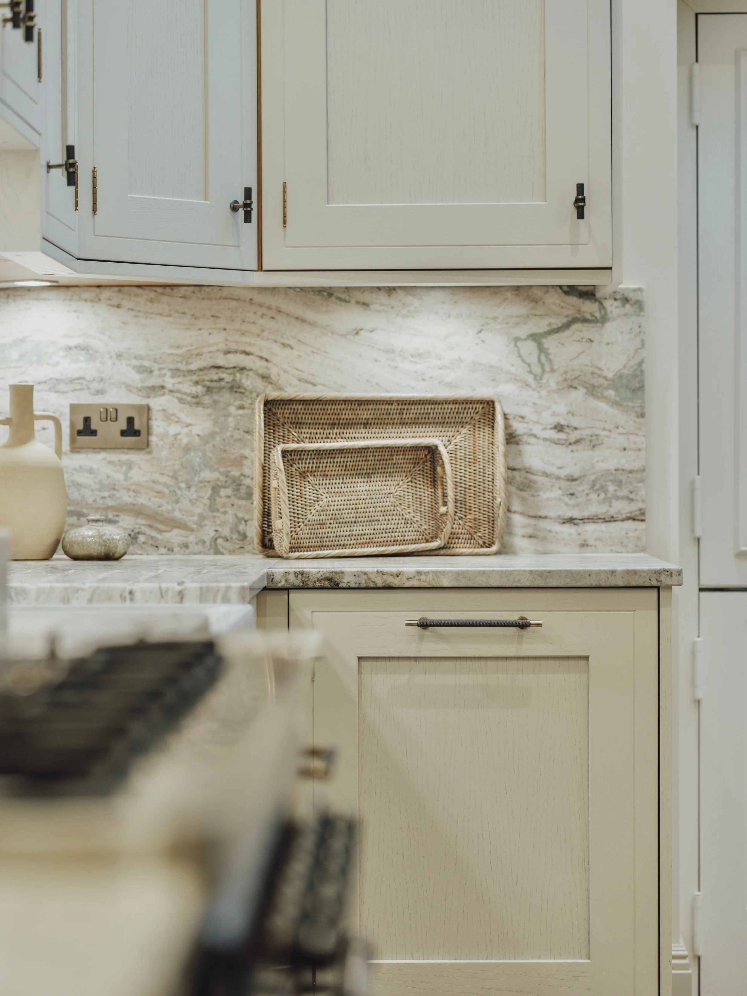 Marble splashback paired with handmade shaker cabinetry and woven trays at Project Orton.
