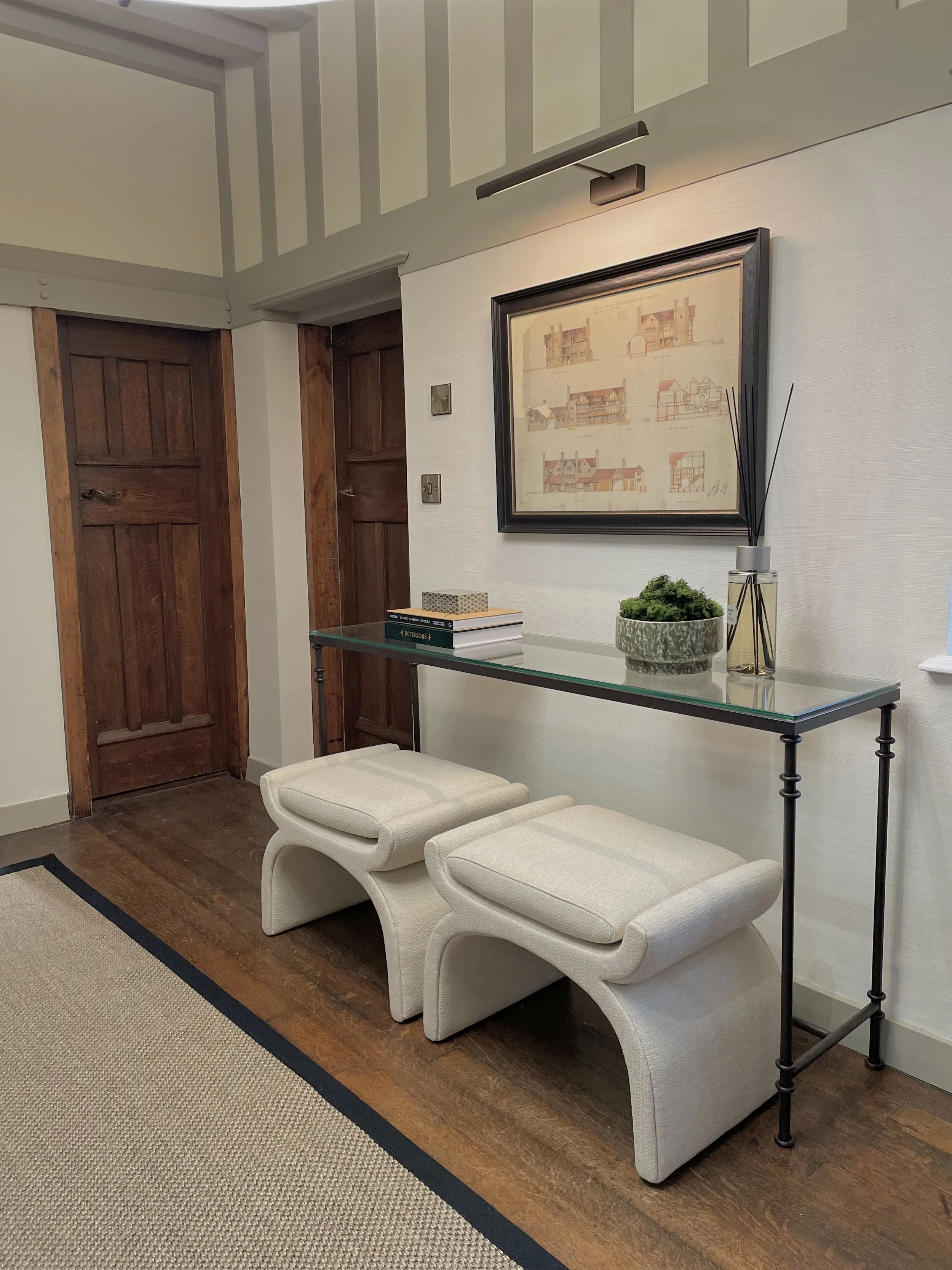 Entrance hall featuring original oak joinery, bespoke staircase runner and curated furniture in a Grade II listed West Midlands home.