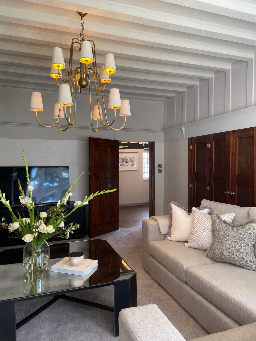 Living room with bespoke furnishings and original timber doors within a Grade II listed West Midlands home.