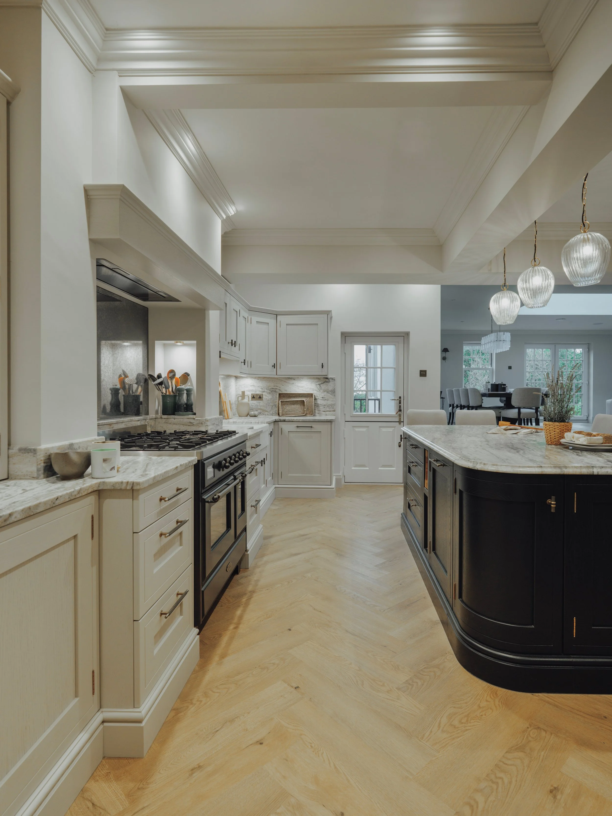 Rounded marble worktop edge and bespoke black kitchen island cabinetry at Project Orton.