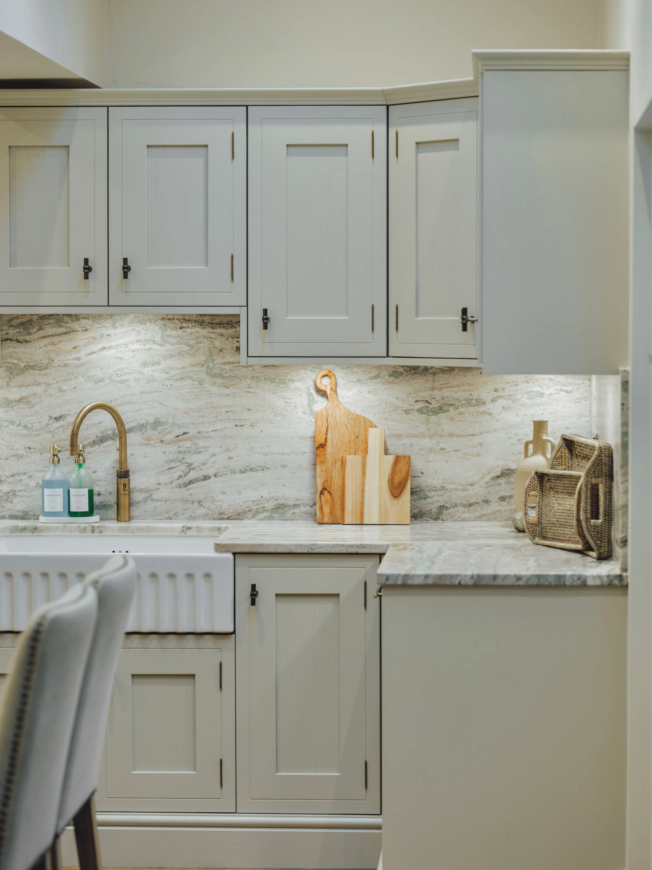 Butler sink with aged Quooker brass hot water tap, marble splashback and bespoke shaker cabinetry at Project Orton.