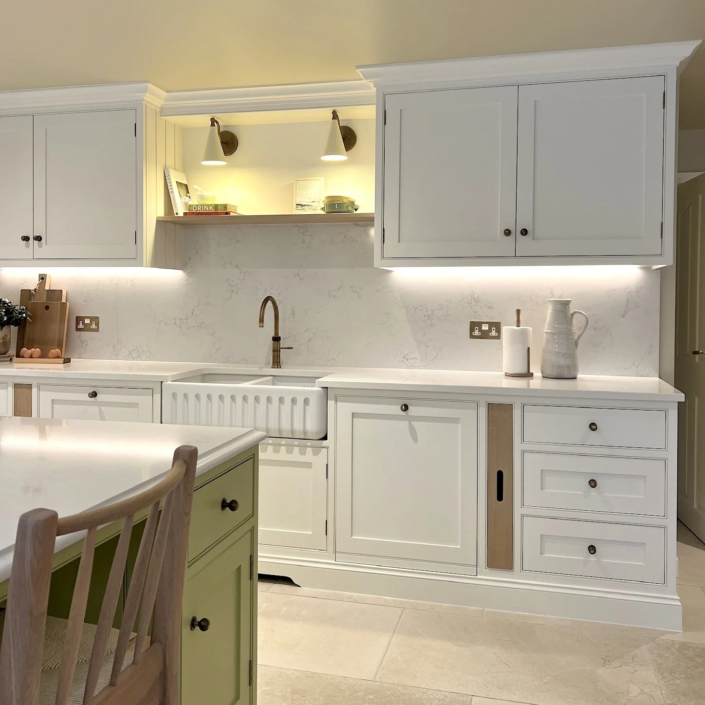 Bespoke shaker kitchen with fluted farmhouse sink, brass tap and quartz splashback in a contemporary West Midlands family home designed by Istigh Interiors.