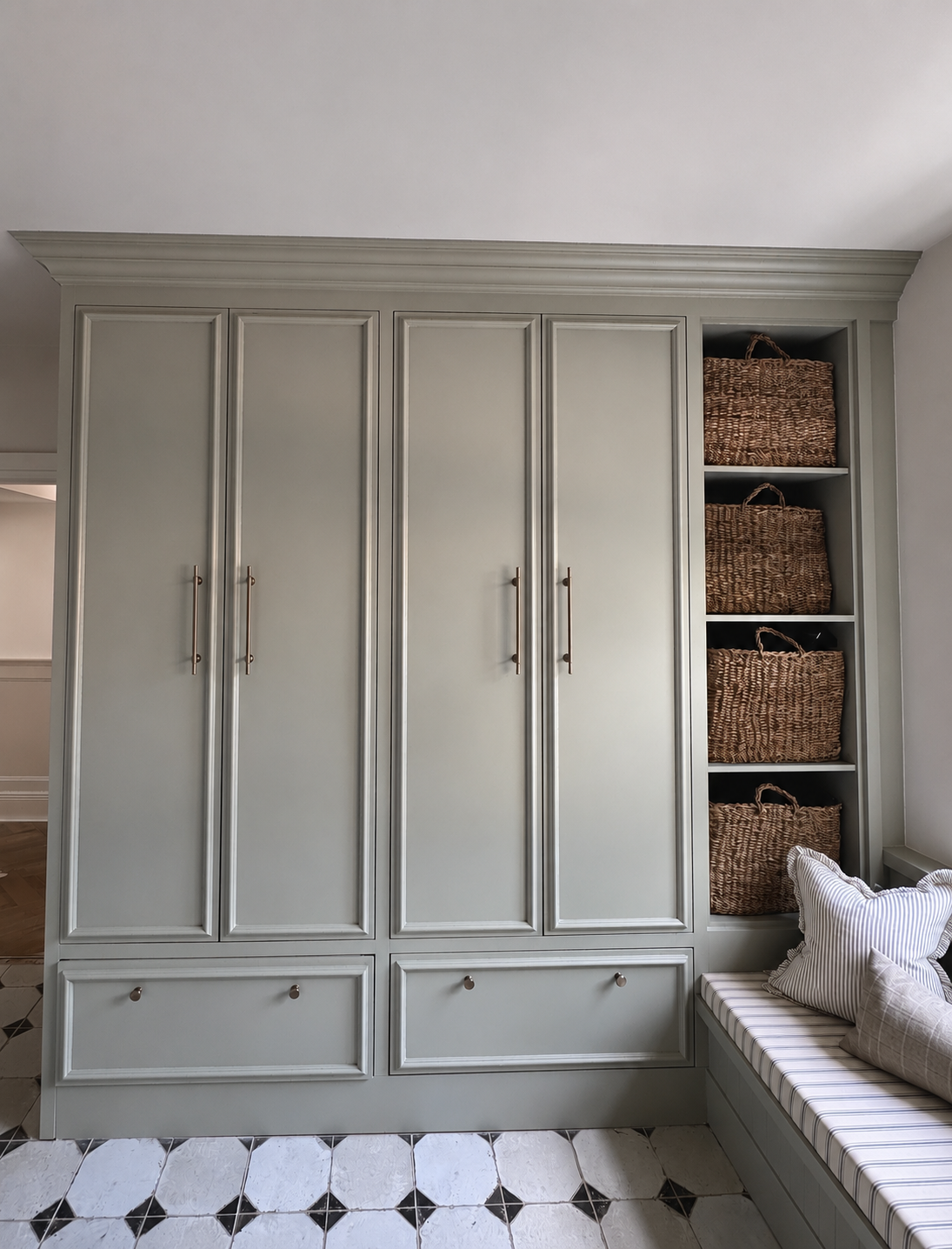 Bespoke boot room cabinetry provides practical family storage with painted joinery, open shelving and integrated seating designed for everyday living.