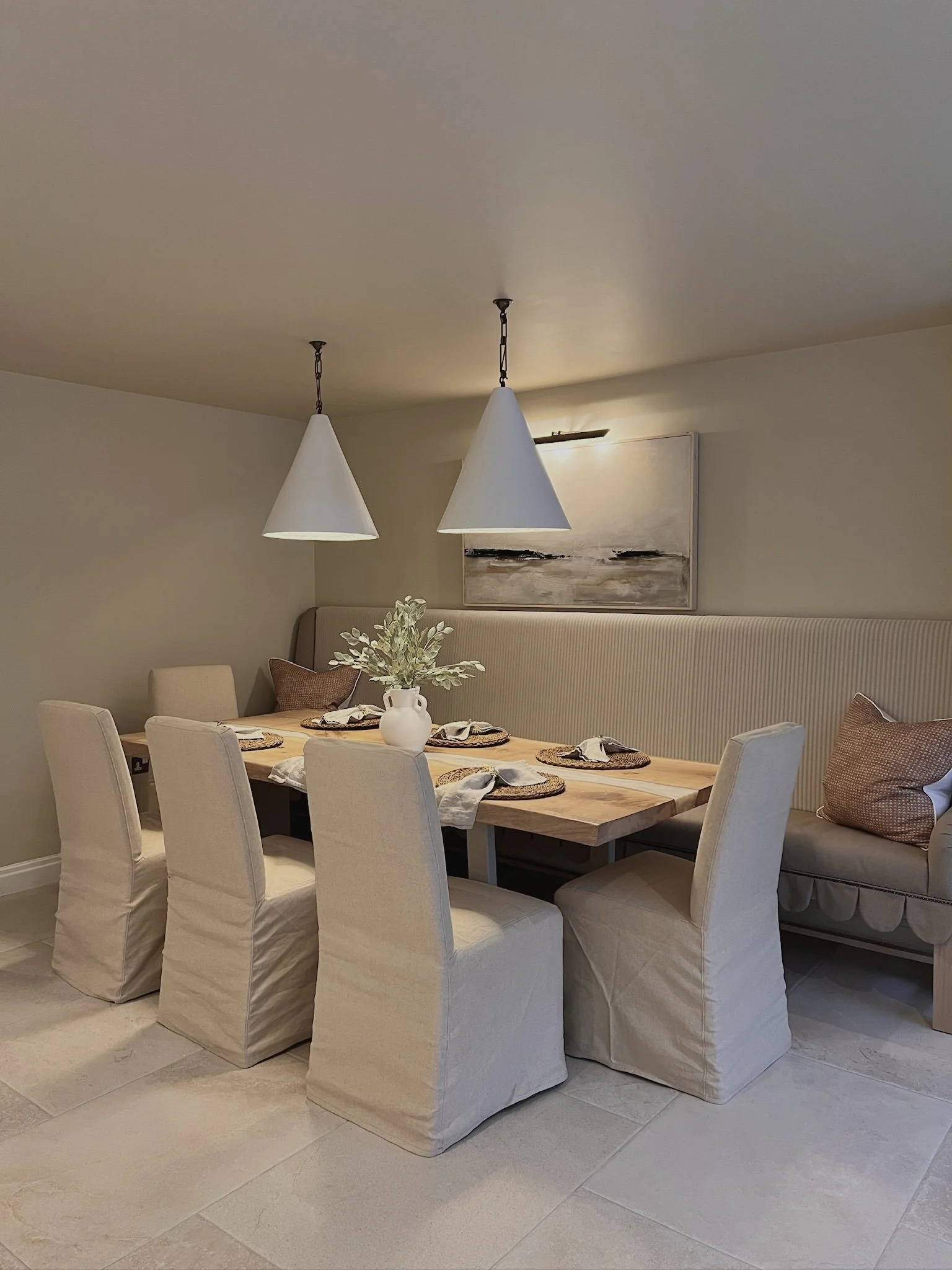 Bespoke banquette seating and oak dining table within a warm neutral dining space at Project Paddock in West Midlands.