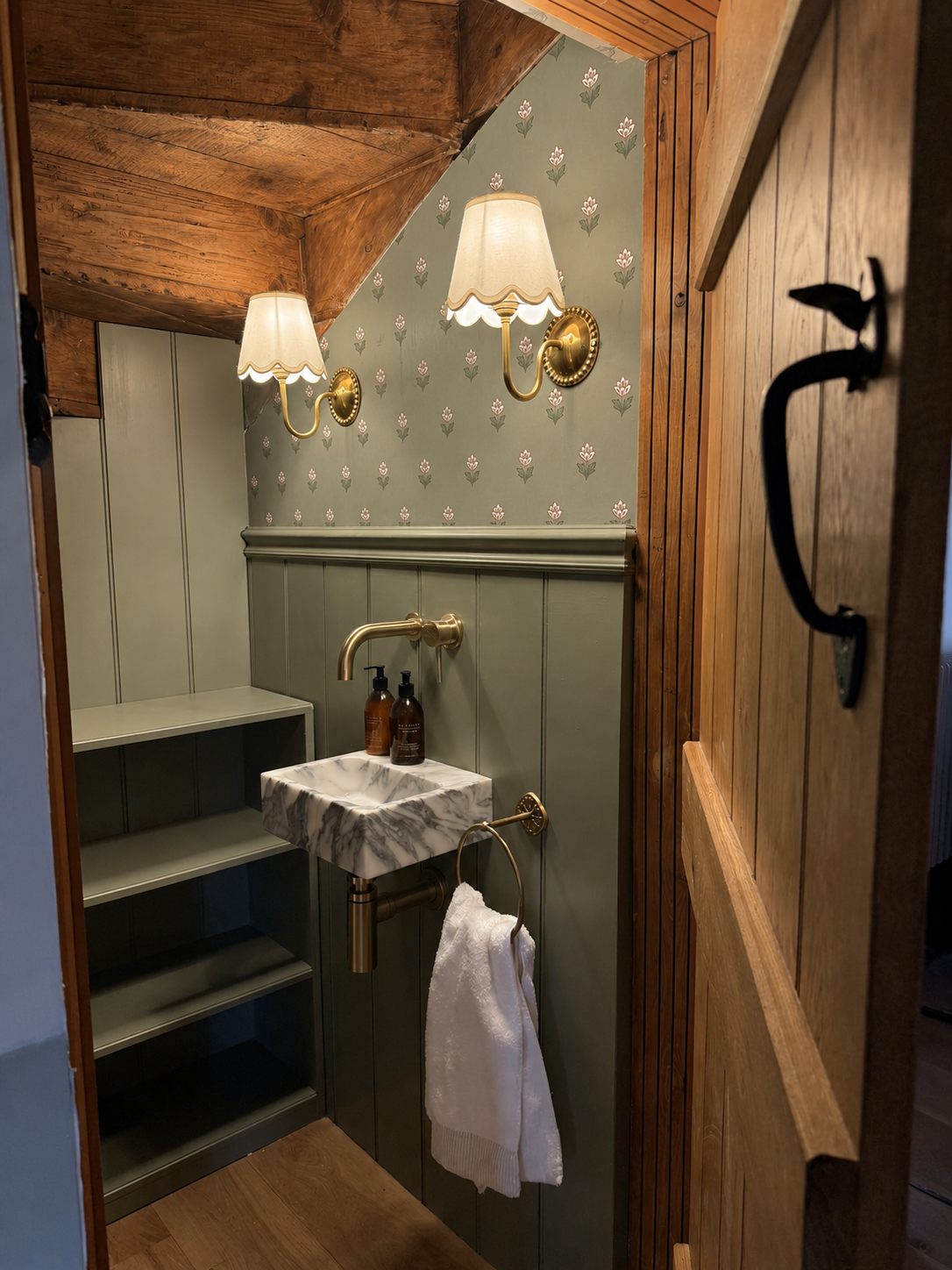 Quirky cloakroom interior featuring decorative wallpaper and bespoke details at Brook Cottage in Bridgnorth by Istigh Interiors.