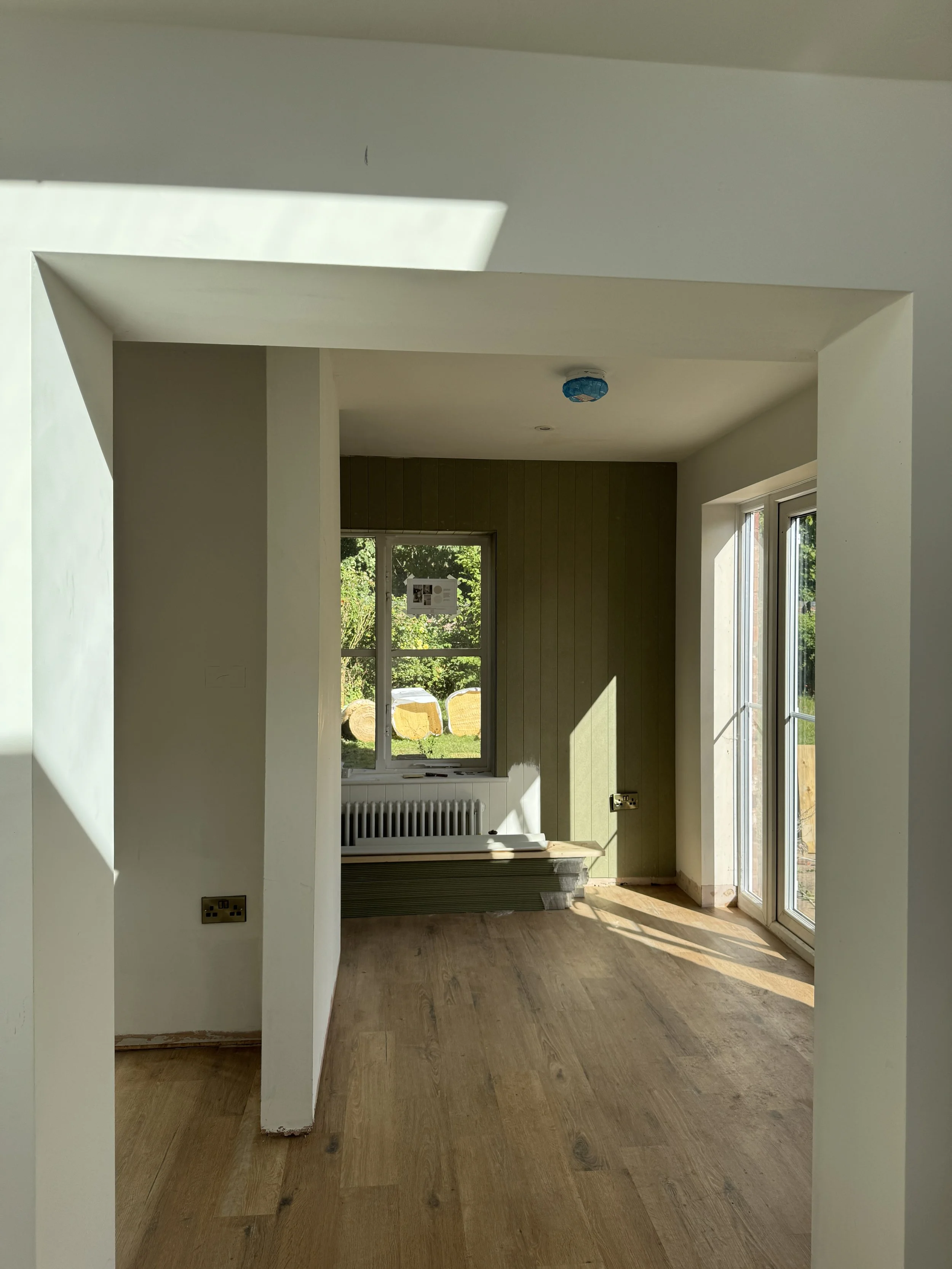 Tongue and groove panelling creating a calm and functional utility with tailored architectural details.