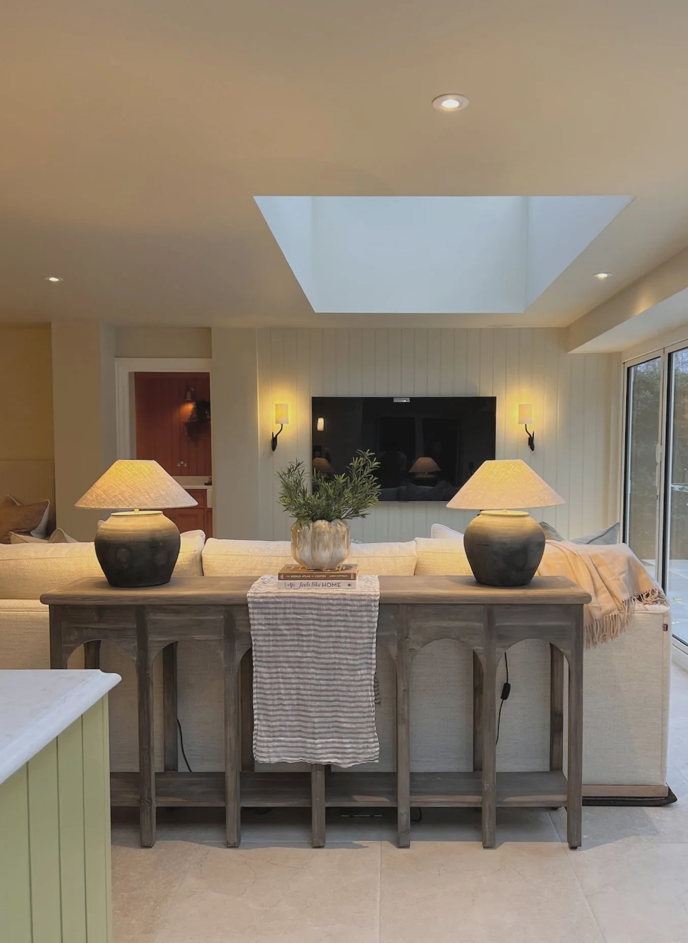 Contemporary open plan kitchen and living extension with skylight, bespoke joinery and layered neutral interiors at Project Paddock, West Midlands.