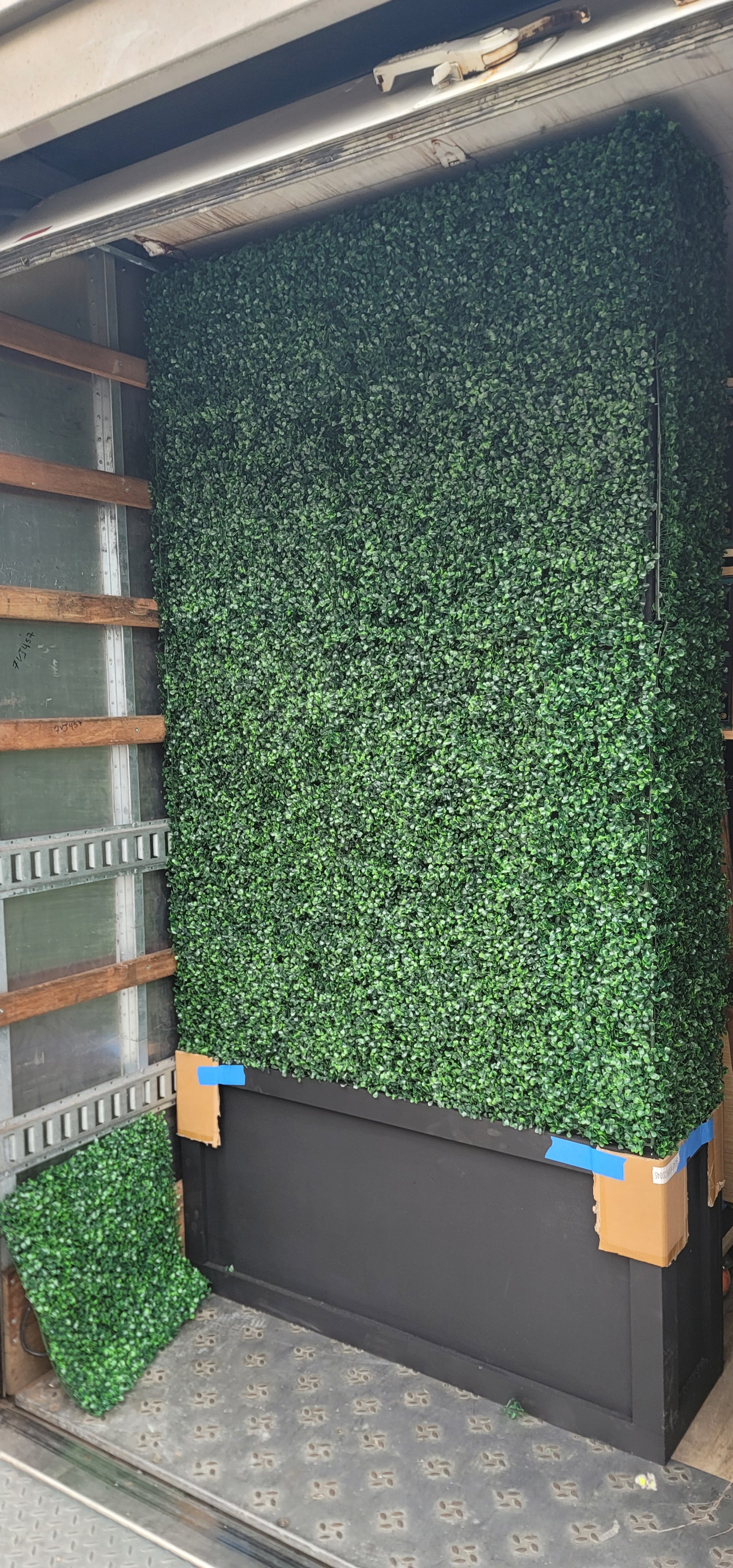 One of the completed faux boxwood hedge units by GhostSquad_Design, shown secured inside a transport truck ahead of delivery for Augusta After Dark during Masters Week. The modular design, caster base, and reinforced structure allowed for efficient l