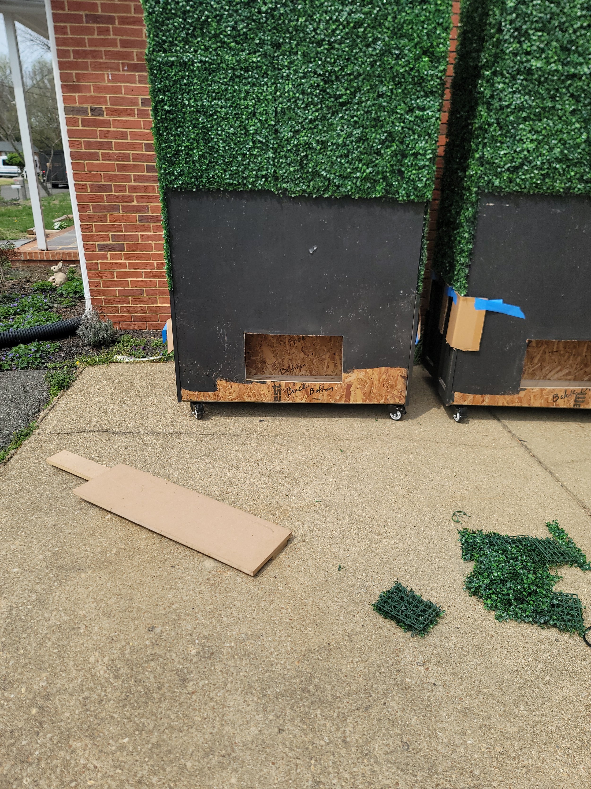 Detail shot of the integrated hatch system on a custom faux boxwood hedge unit by GhostSquad_Design, created for Augusta After Dark during Masters Week. The hatch allows access to internal sandbags used as counterweights, ensuring stability in outdoo