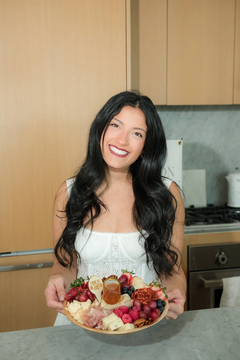 Carissa holding one of her charcuterie boards