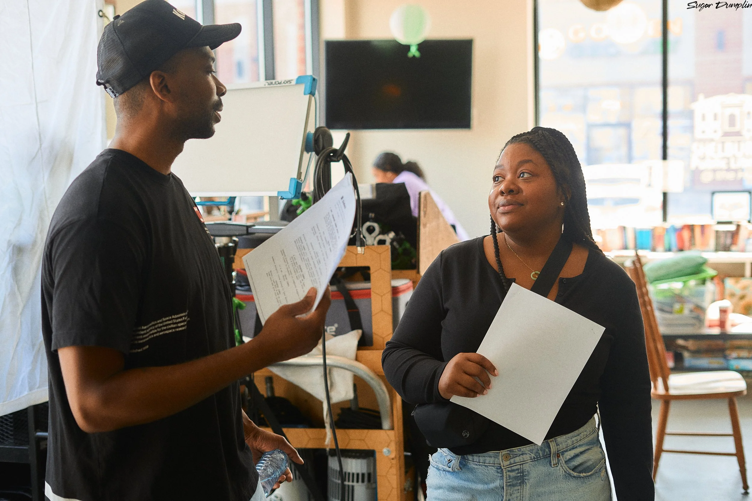 Executive Producers Kern Carter and Safia Bartholomew, doing script supervising on the set of Sugar Dumpling, short film directed and written by Tristan Barrocks. 