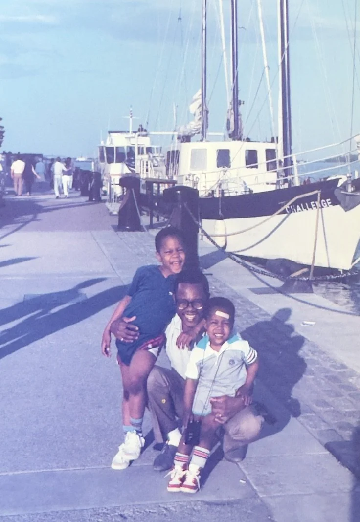 A picture of Jamaican-Canadian director, award-winning director Tristan Barrocks, with his father and older brother Sheldon Barrocks. His father's name is Bobby Barrocks.