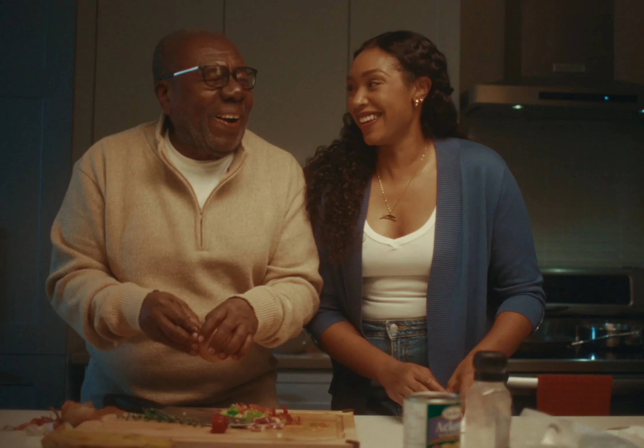 Warm moment between Desmond James, aka Oliver Samuels, and Ebony James, aka Chantal Riley, connecting through their love of food on the set of Sugar Dumpling 