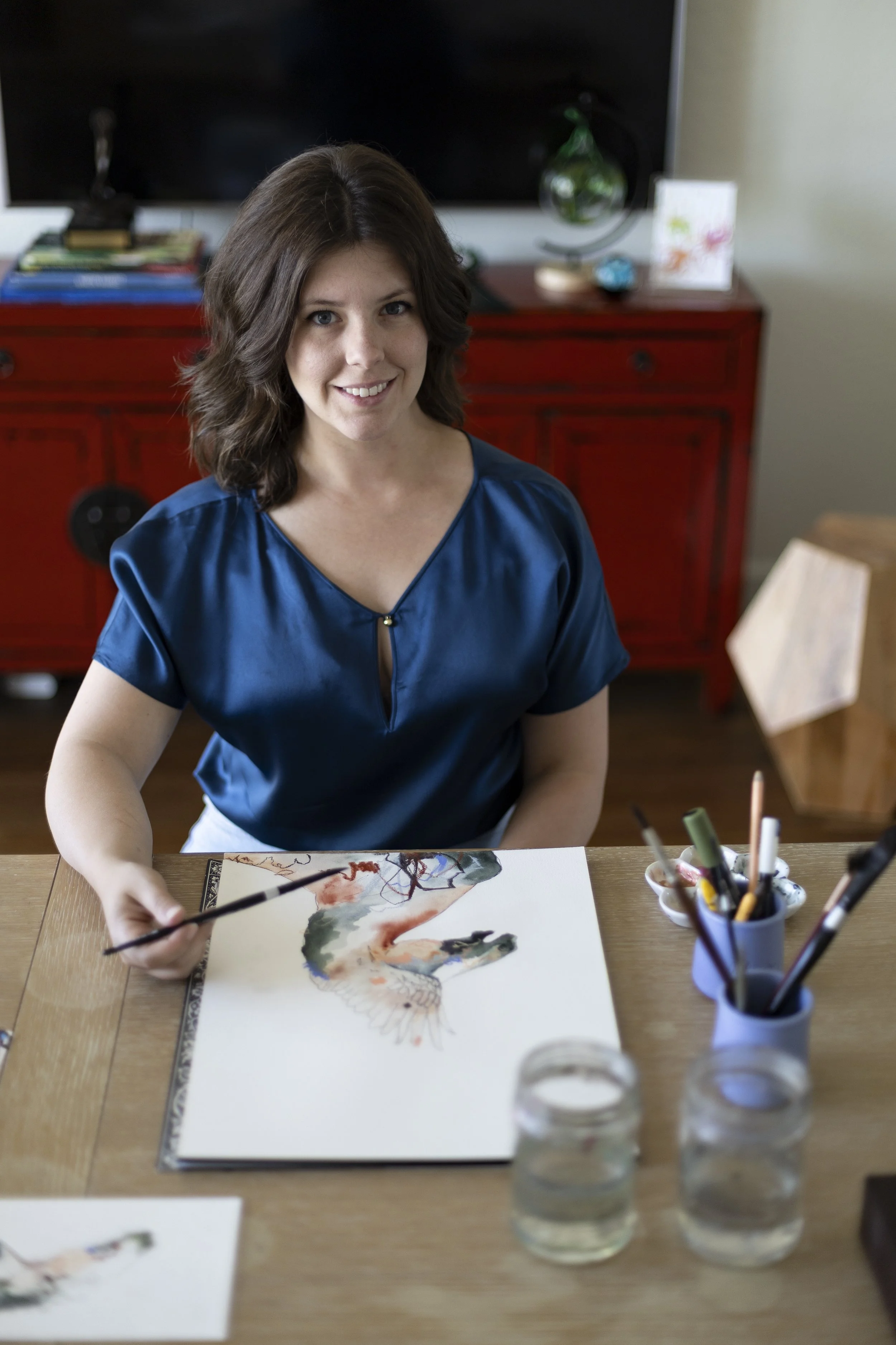 Artist Ellen MacEwan working on a painting in the studio