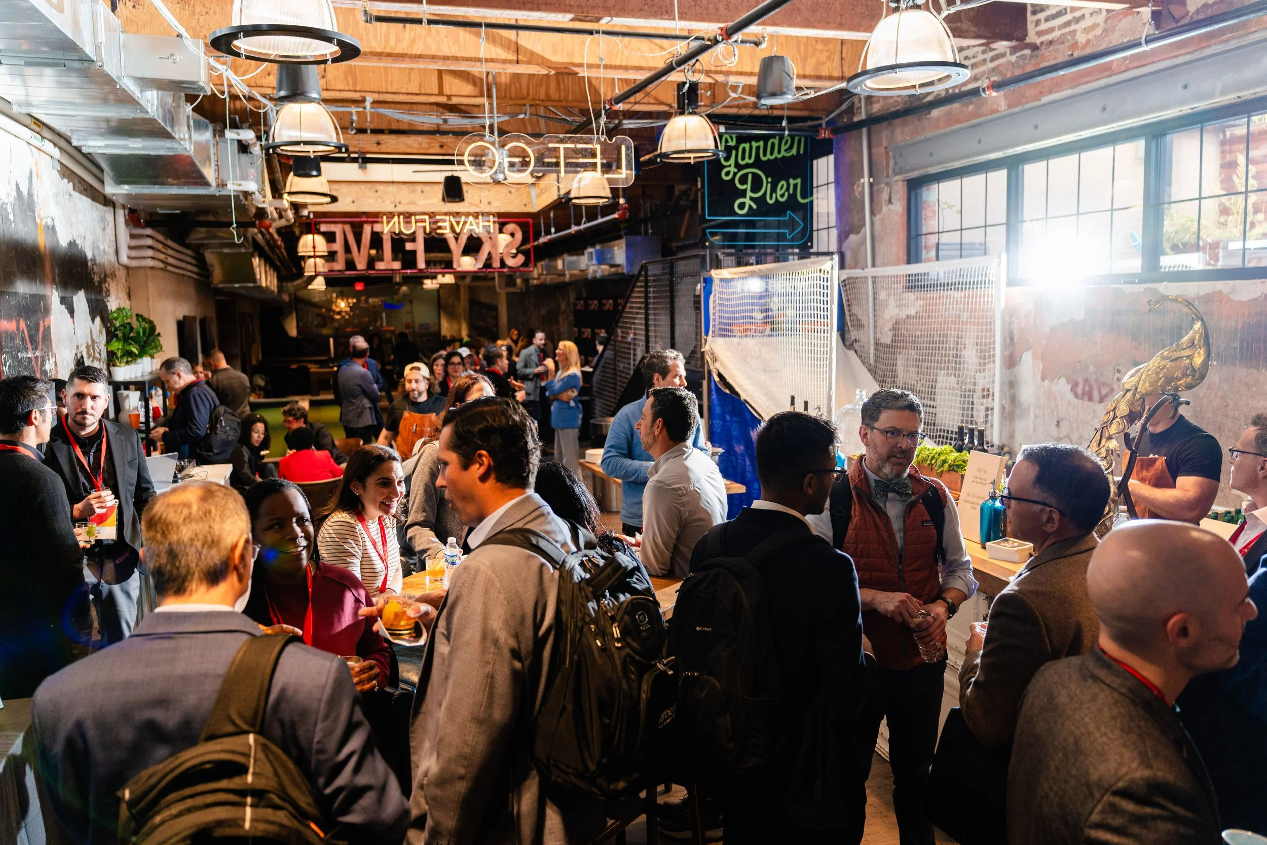 A candid photo of a group of O3 conference attendees at a happy hour