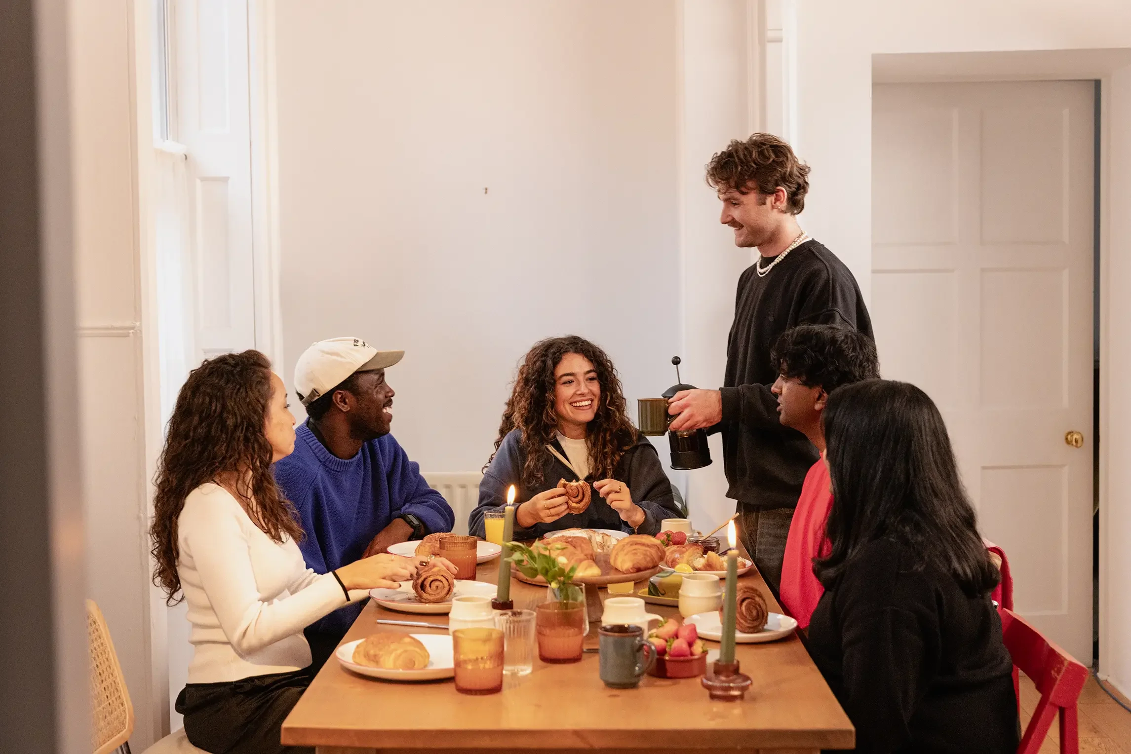 Friends gathered around a table sharing a meal.