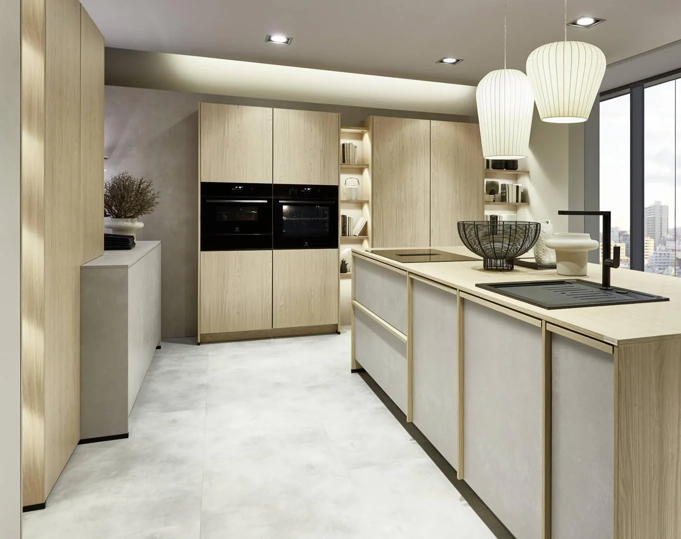 Modern kitchen with light wood cabinets, a kitchen island with a sink, black faucet, and hanging white pendant lights, overlooking a city skyline through large windows.