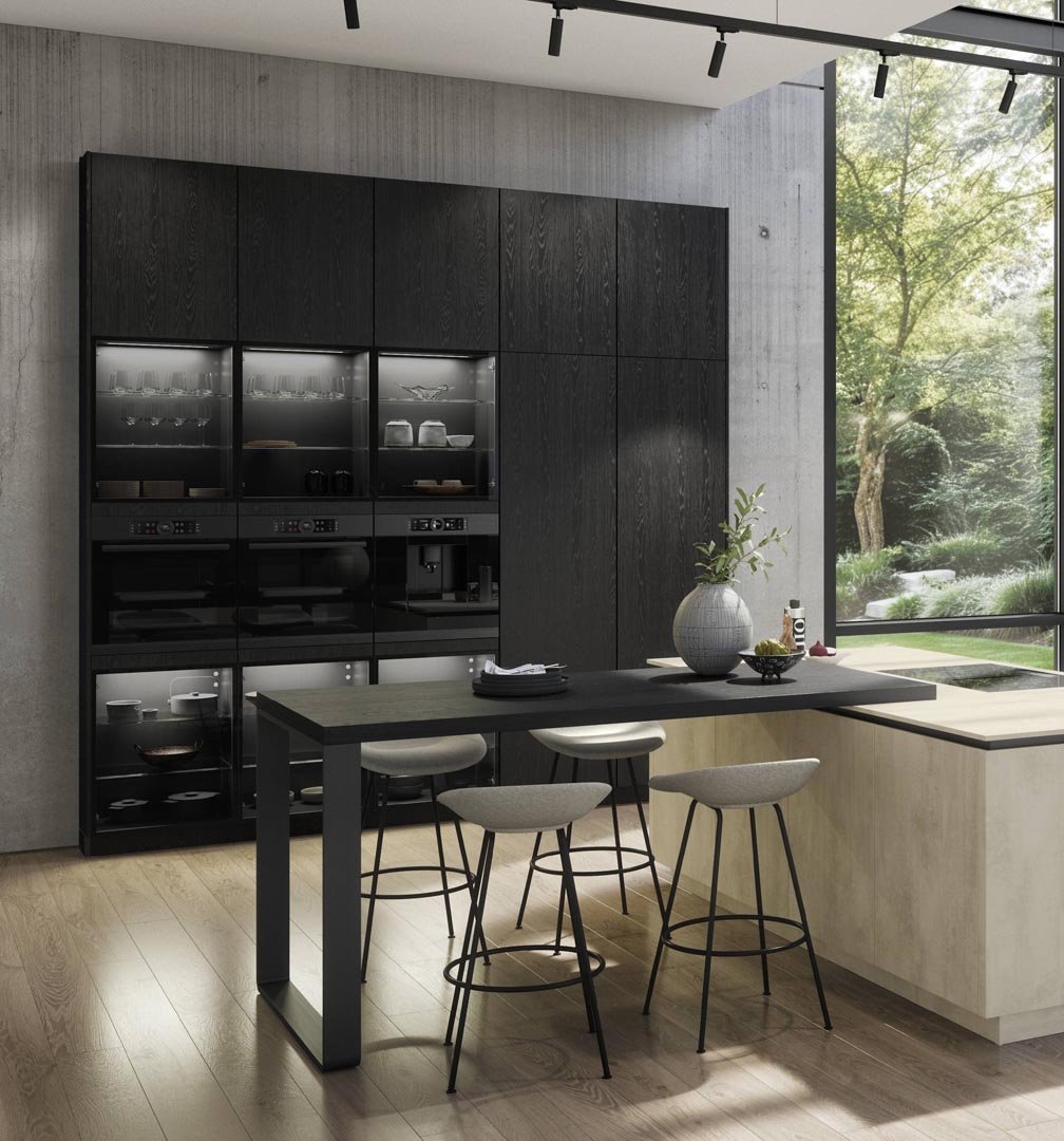 Modern kitchen with black cabinetry, a small dining table with four chairs, and a large window showing a garden outside.