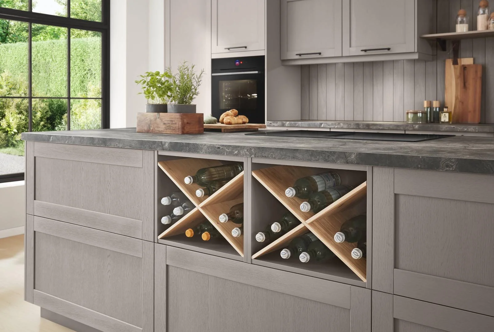 Modern kitchen island with built-in wine storage and gray cabinetry.