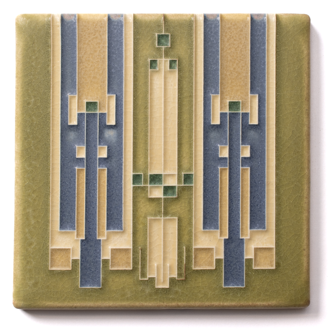 A vintage tile with an abstract geometric pattern in green, beige, and dark blue colors.