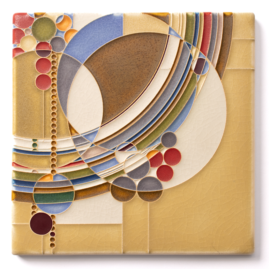 A colorful abstract ceramic tile with geometric patterns and circles in shades of yellow, blue, red, green, brown, and gray.