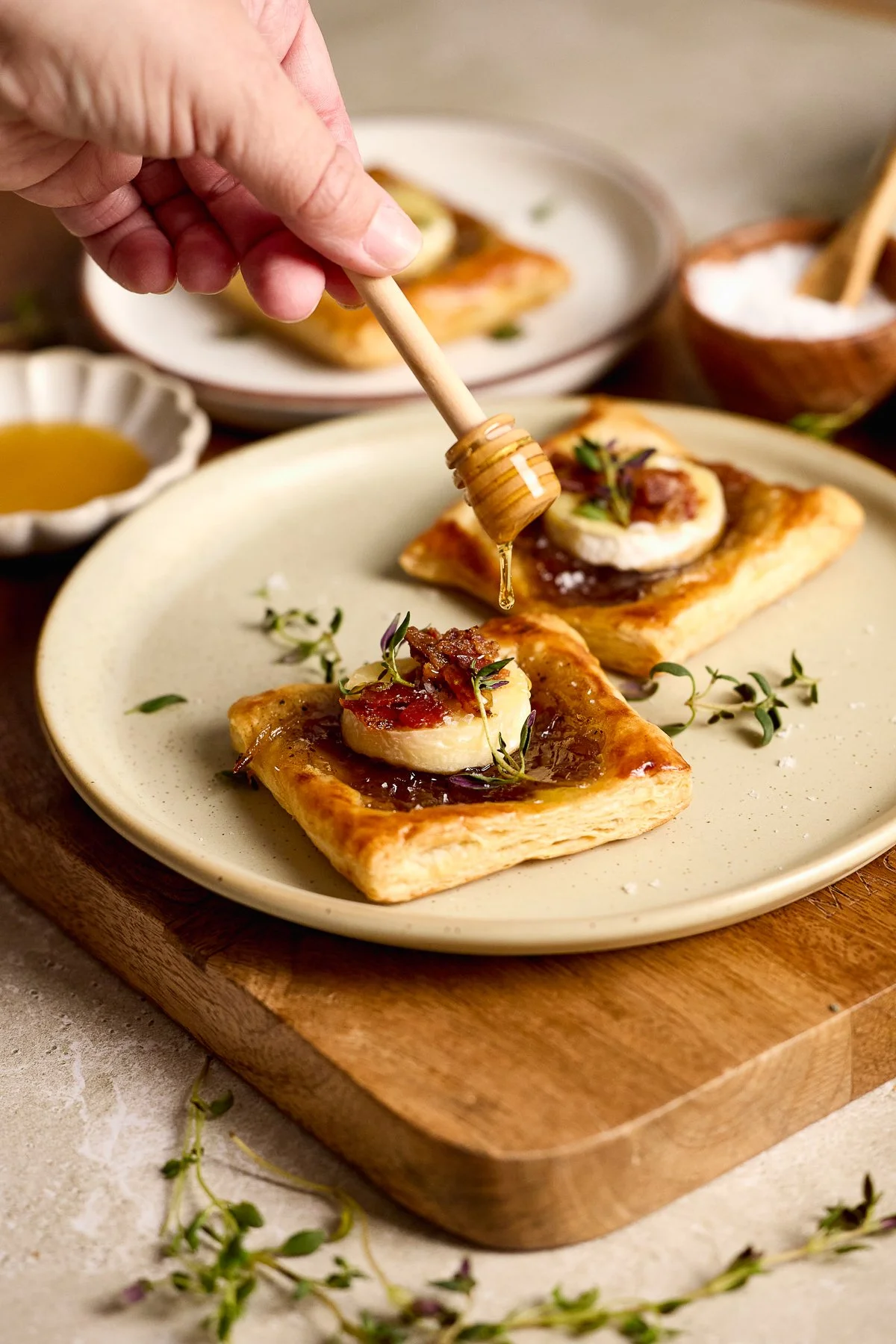 Puff pastry with brie bites, crumbled bacon, carmelized onion jam and thyme drizzled with honey