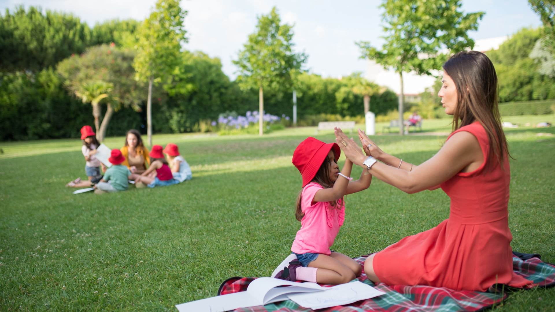 Professional summer nanny and happy child smiling in the park, elite childcare placement services by A Mother's Prayer.