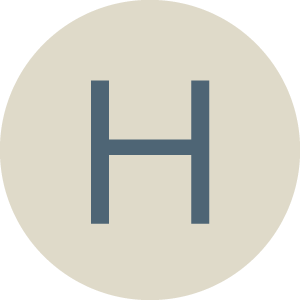 Letter H inside a circle with a light background.