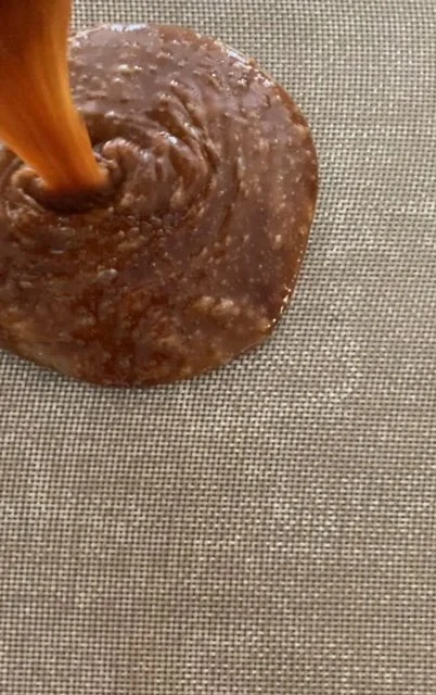 Toffee being poured onto a mat to set