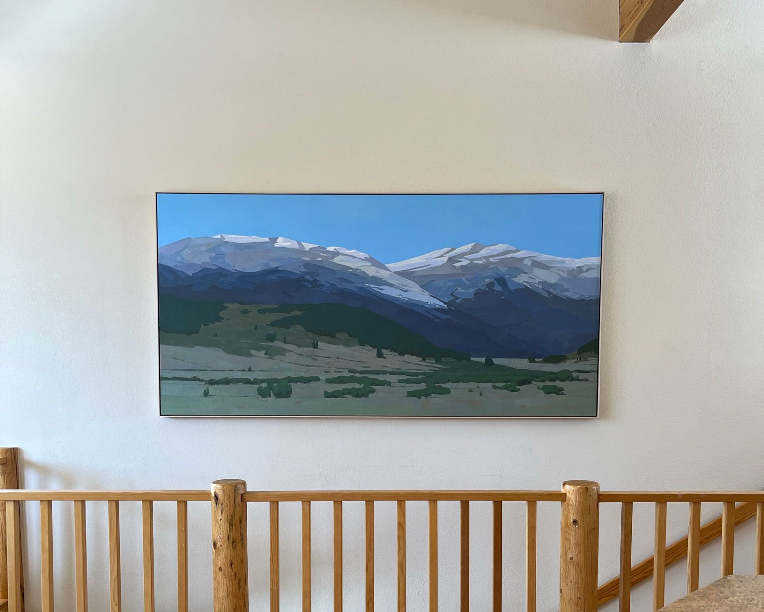 A large painting of the Colorado mountains in Breckenridge. Installed over stairs in the collector's cabin.