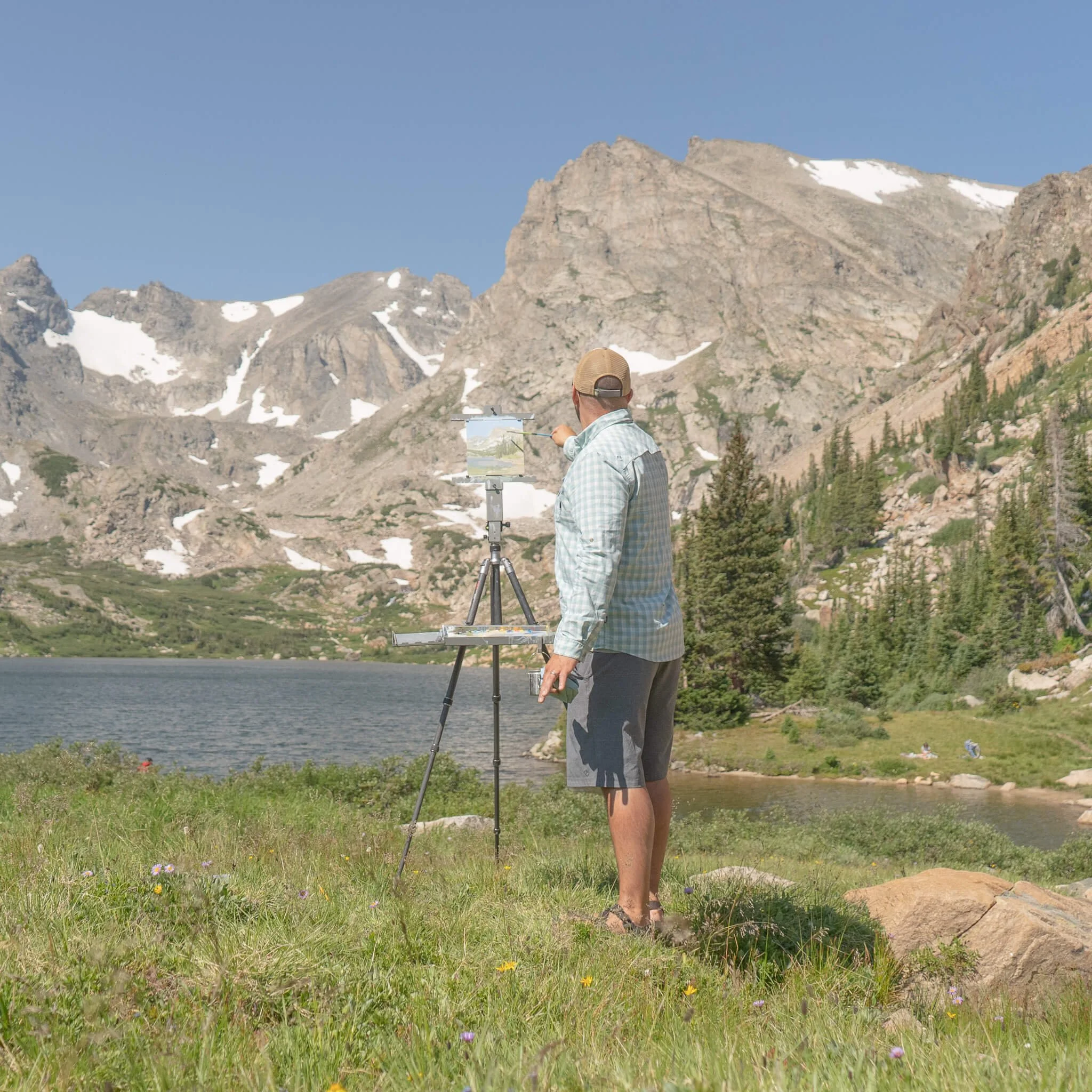 Michael Magrin painting in a plein air setting at a high altitude lake and mountain setting