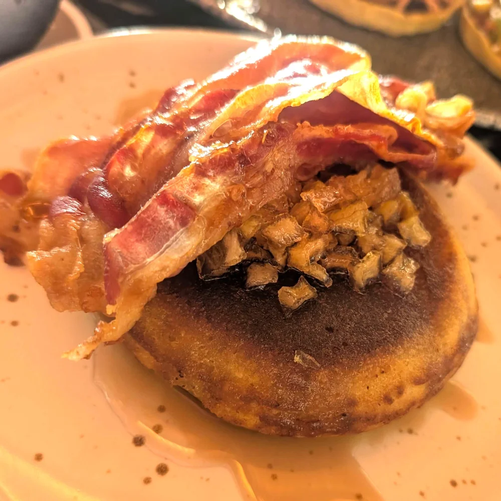 Sourdough pancakes with maple syrup, bacon, and apple-sage compote at Seaside Beach Club in Playa del Carmen.