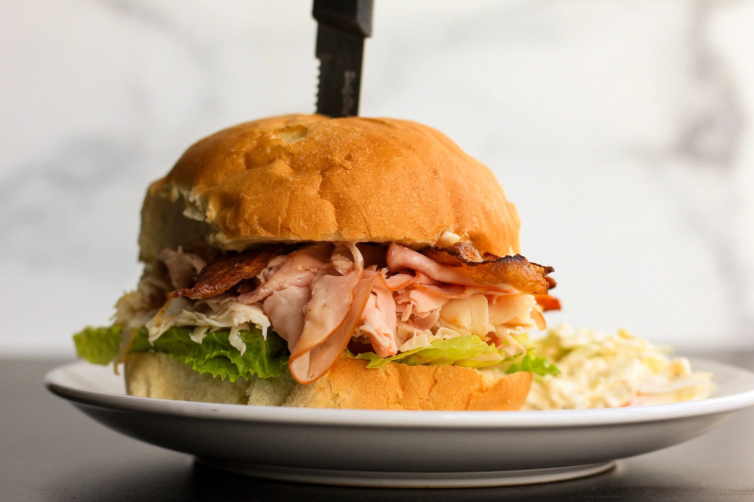 coastal coffee roasters club sandwich lunch item is a delicious and filling choice when eating at a local cafe