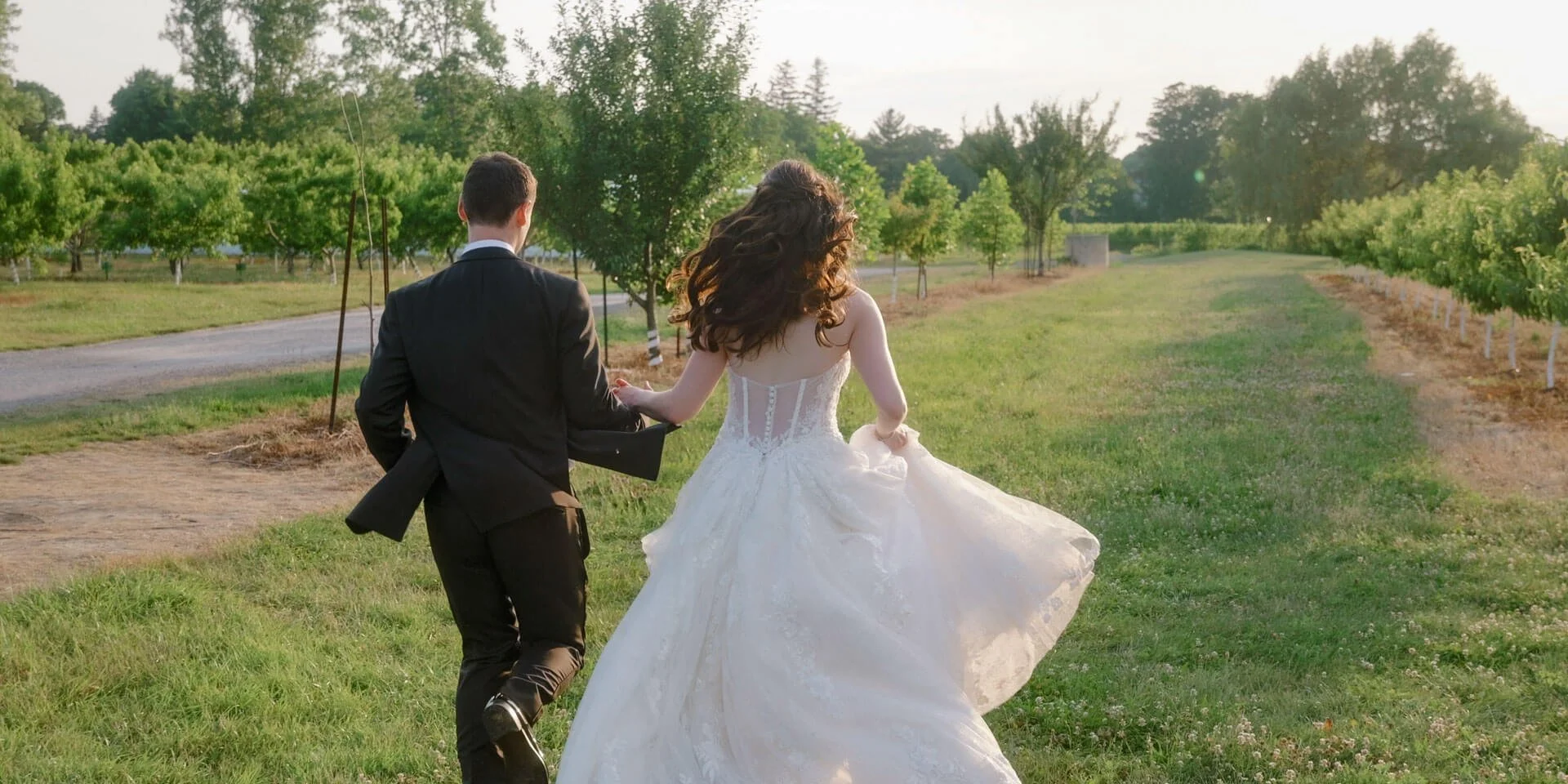 Bride and groom running in wedding attire