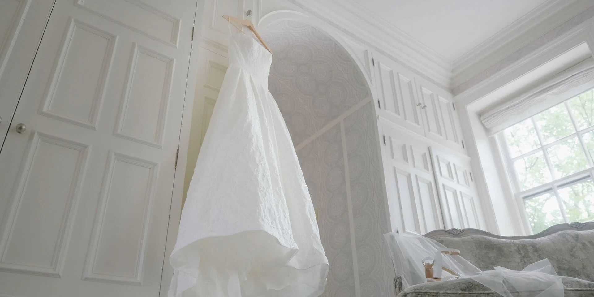 wedding dress hanging in bridal suite