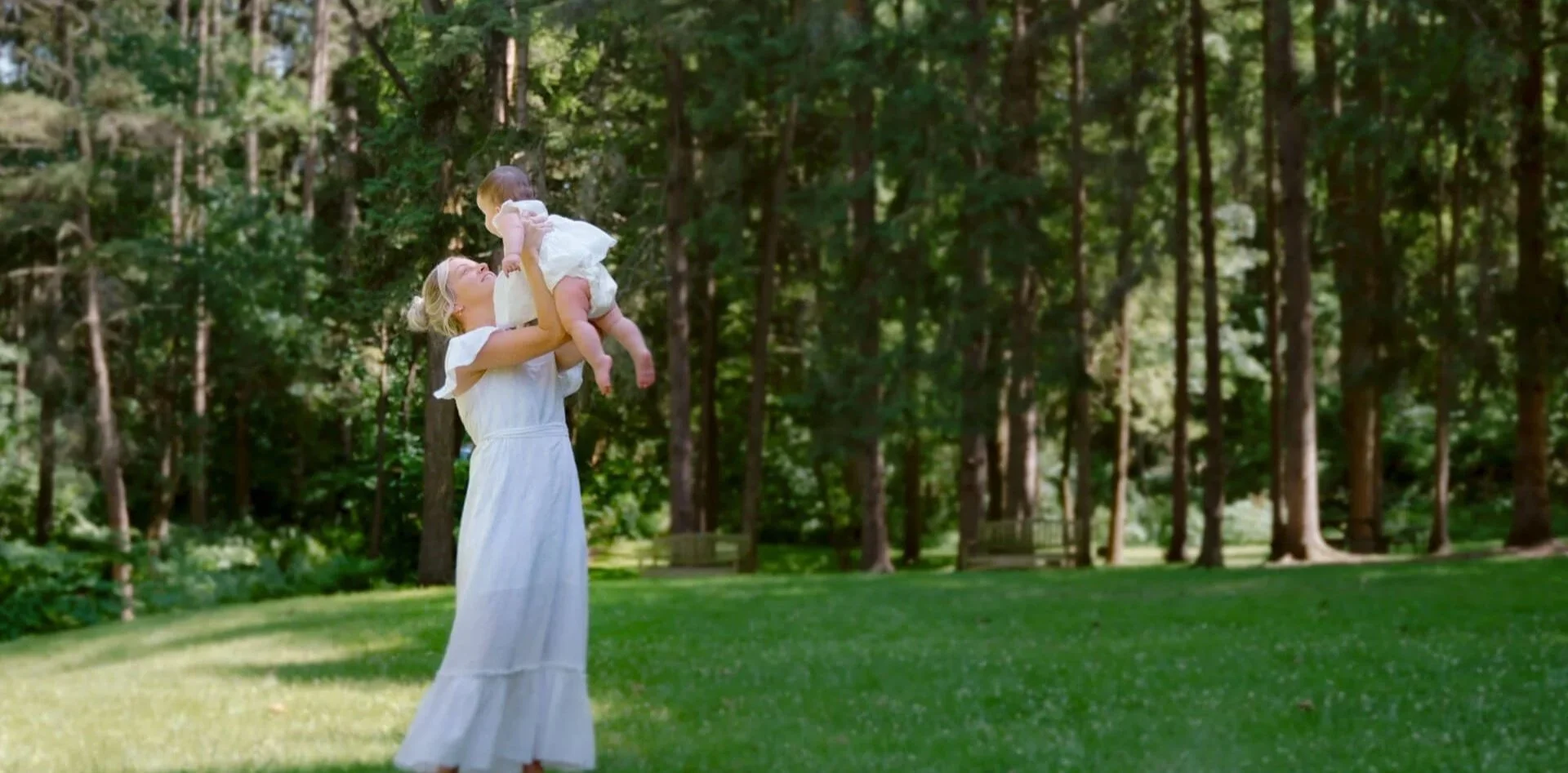 woman holding her daughter in a forest