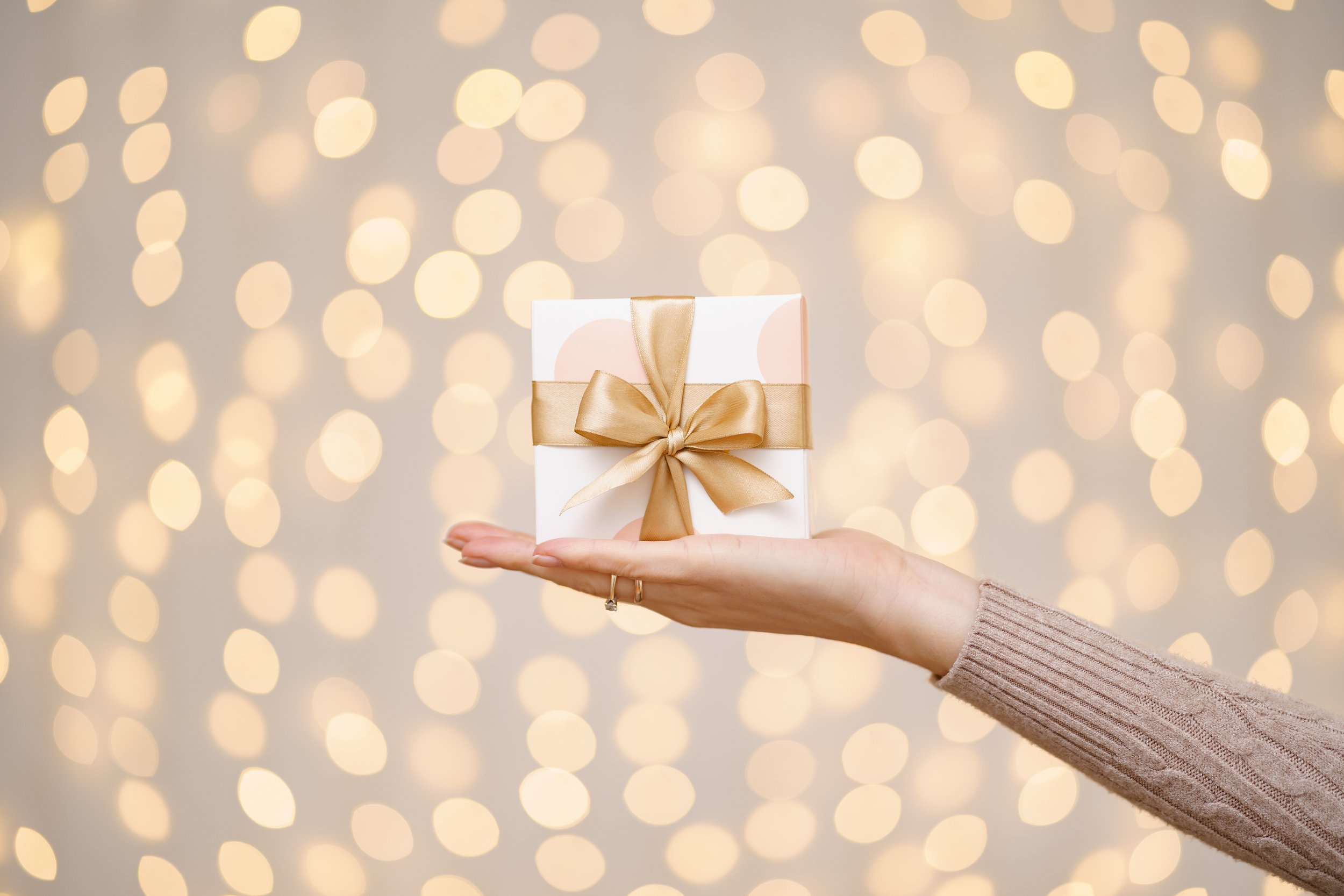 a-magical-glowing-present-box-being-holded-by-a-wo-2024-10-21-09-02-25-utc.jpg
