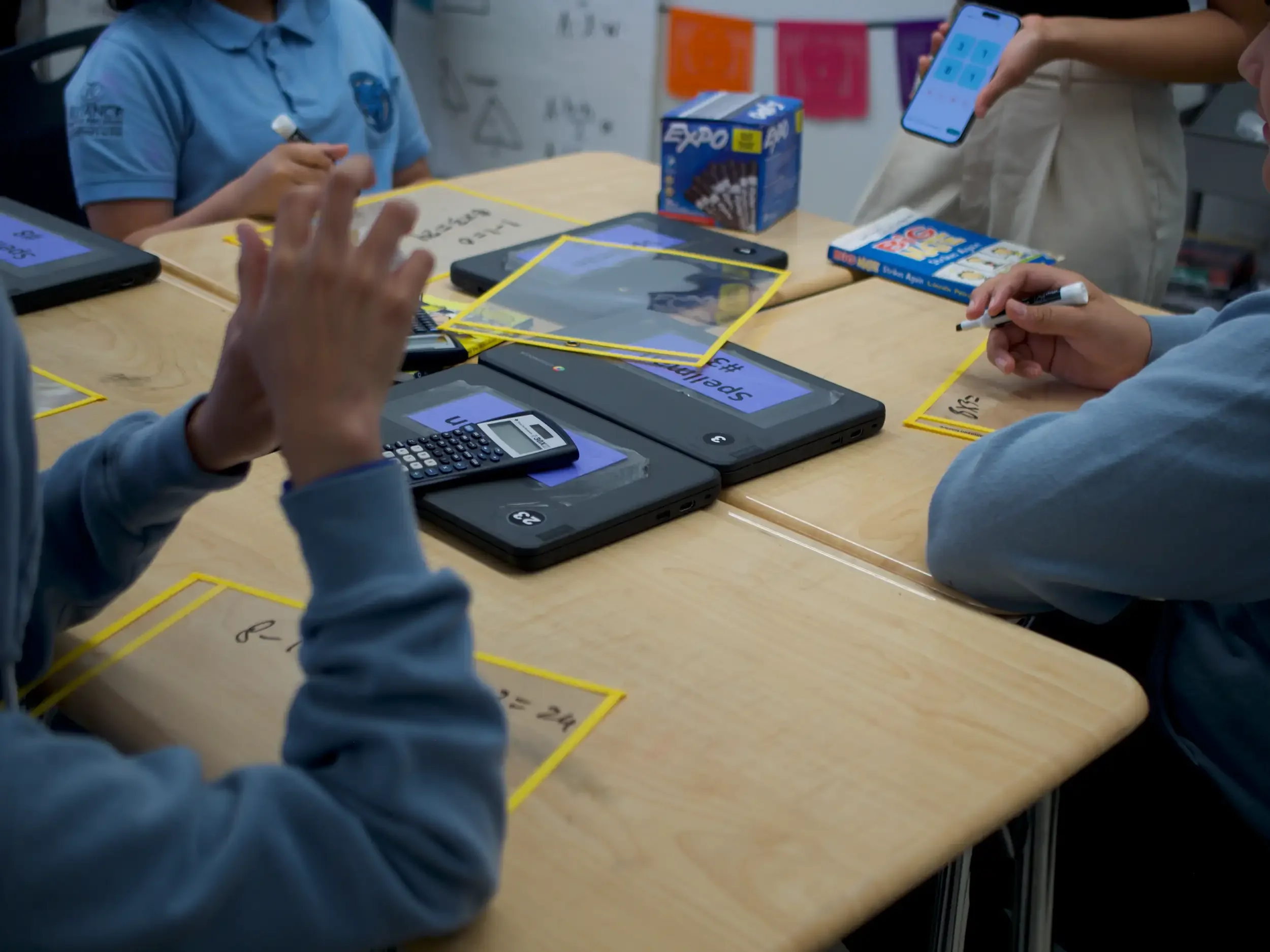 K-12 students engaged in an interactive small-group math lesson.