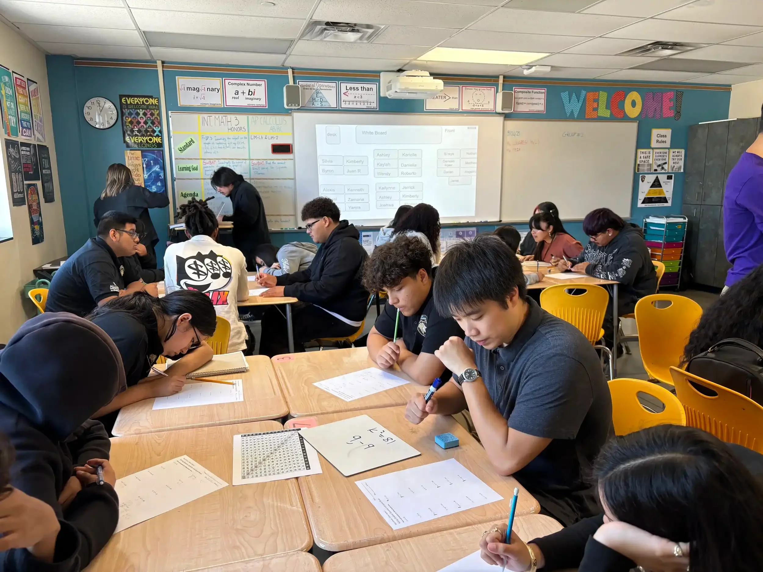 An in-class tutor engaging with high school students