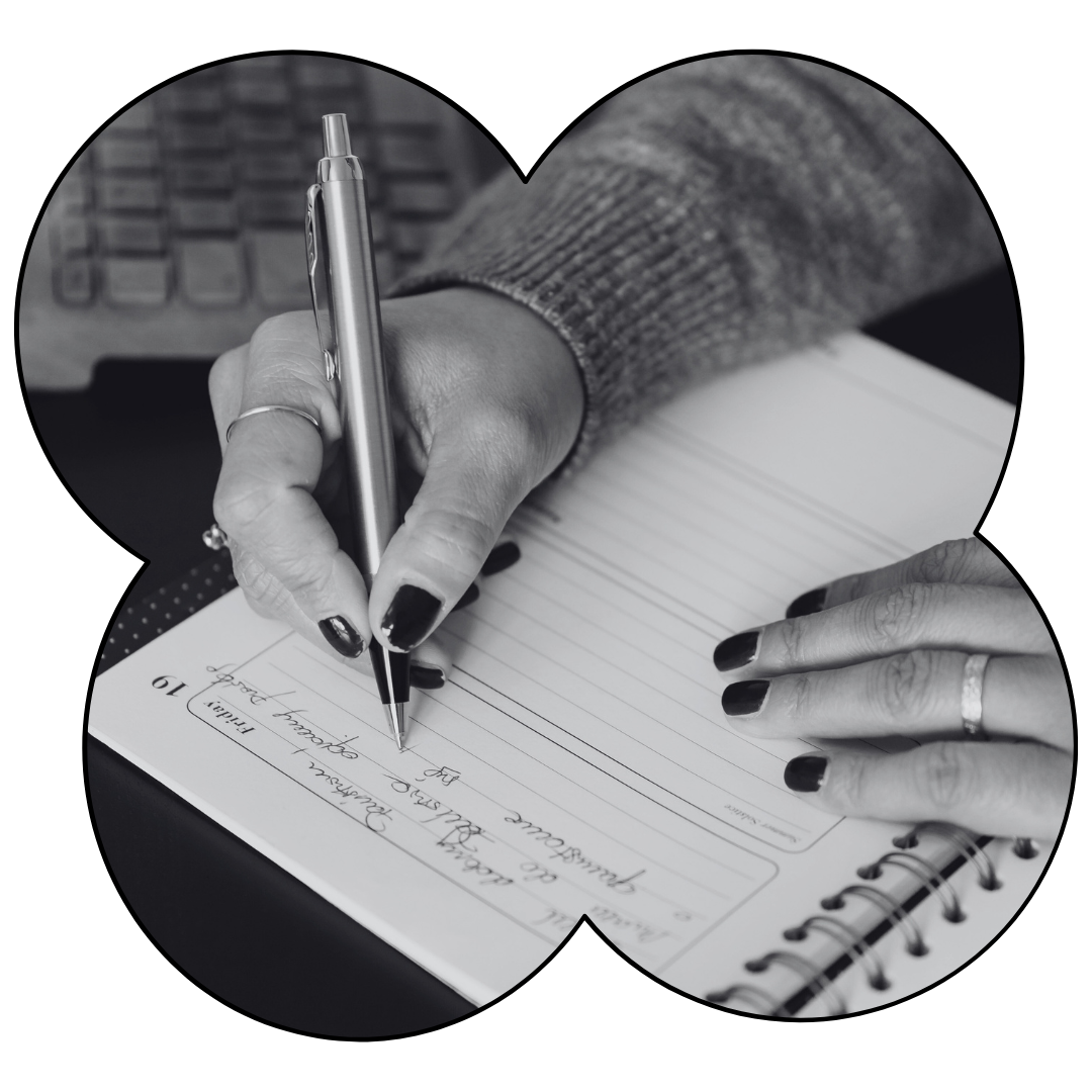 Close-up of a woman writing in her journal, reflecting on mental health goals and anxiety-reducing resolutions