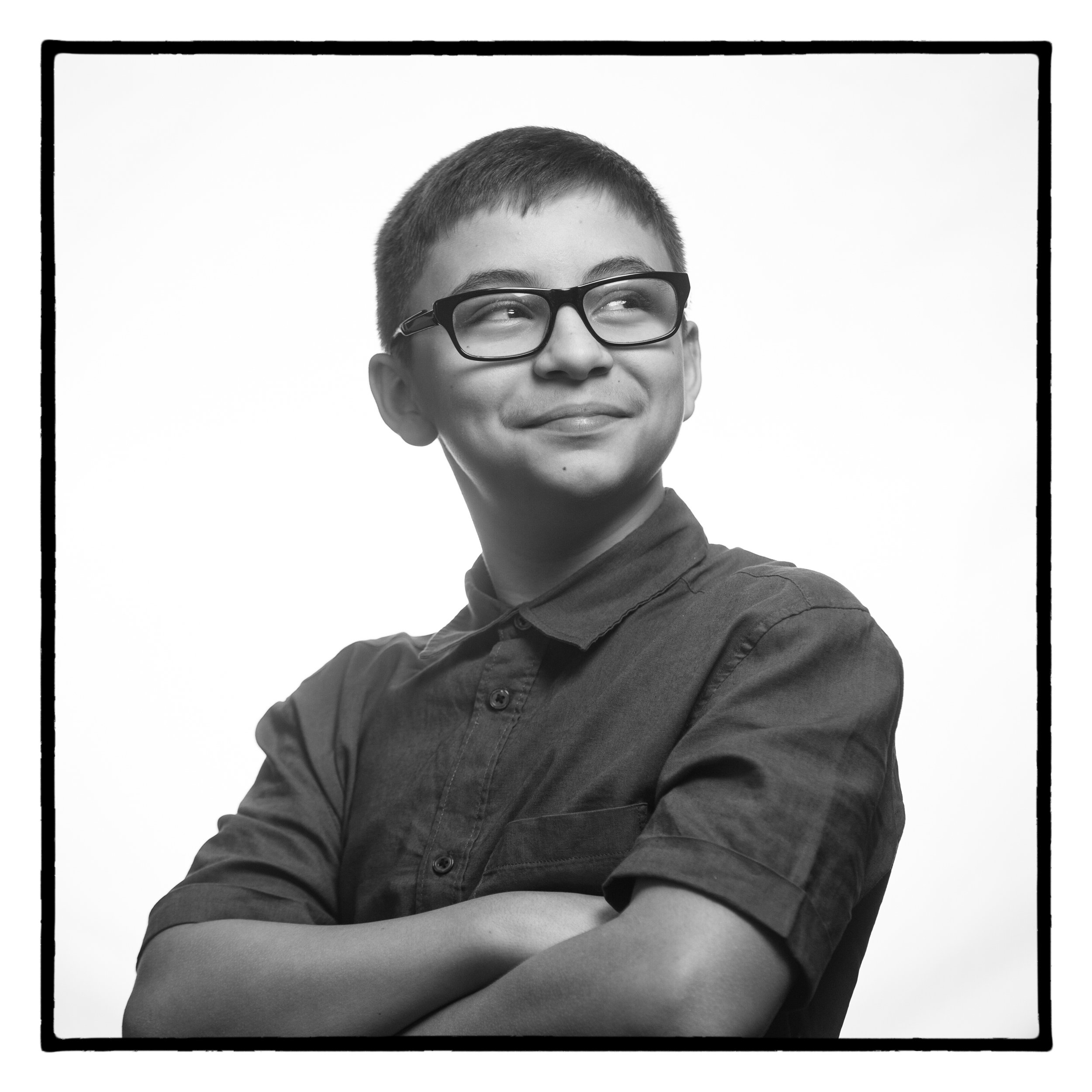 black and white portrait of boy looking off in the distance